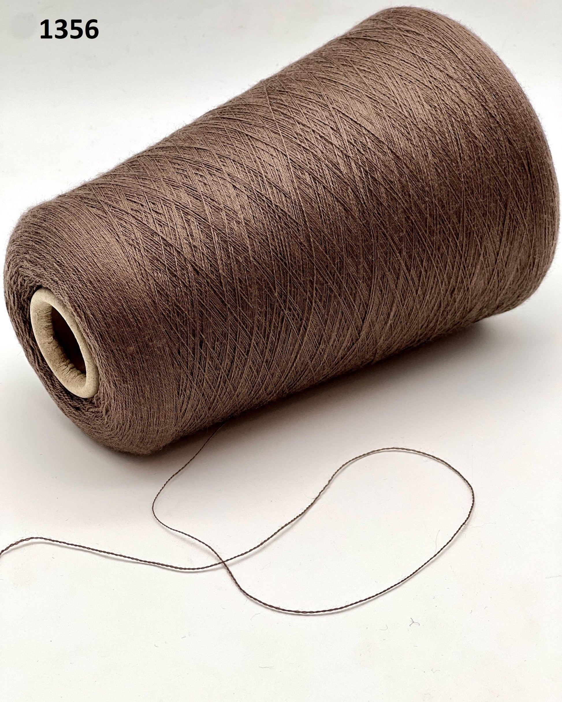 Brown spool of thread on a white background
