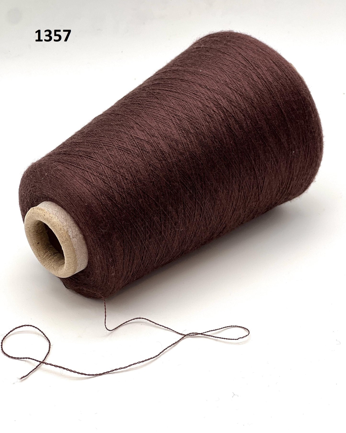 Brown spool of thread on a white background