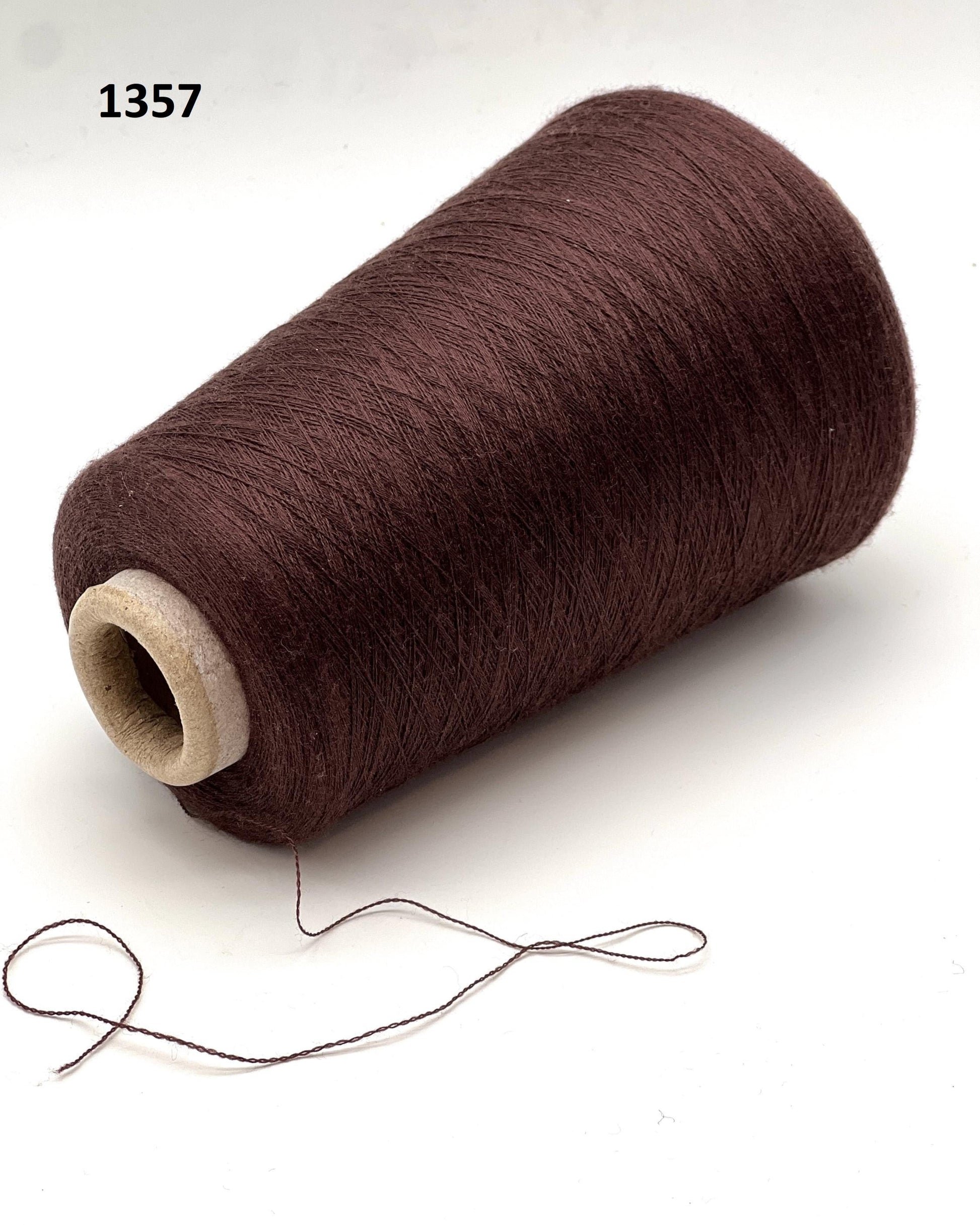 Brown spool of thread on a white background