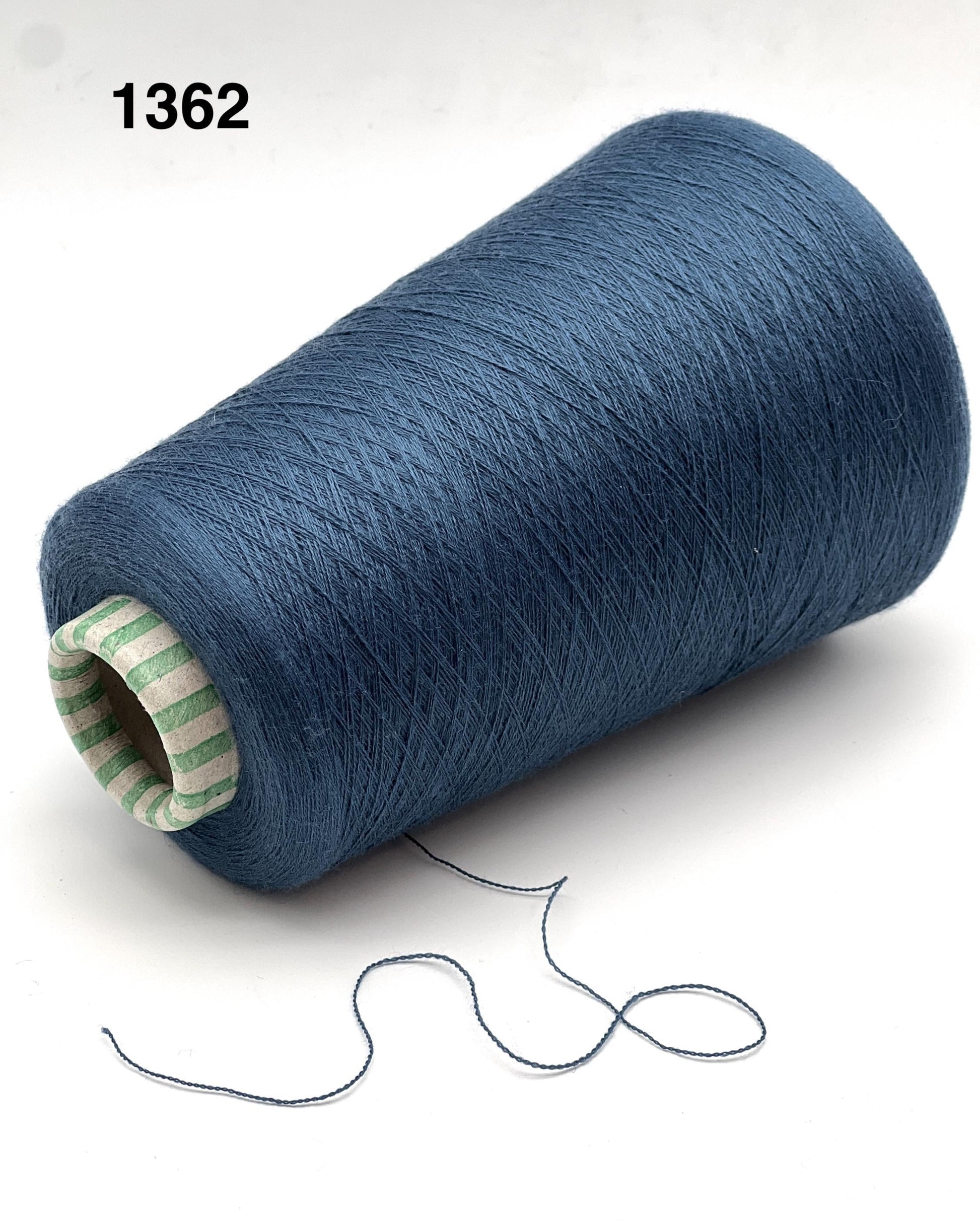Blue spool of thread with a small amount of thread extending on a white background