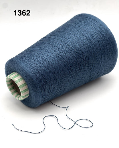 Blue spool of thread with a small amount of thread extending on a white background