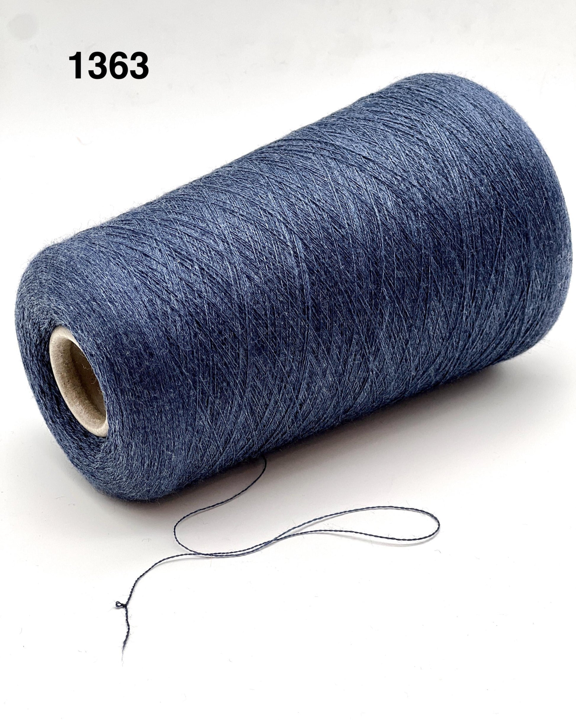 Roll of blue yarn with a string on a white background