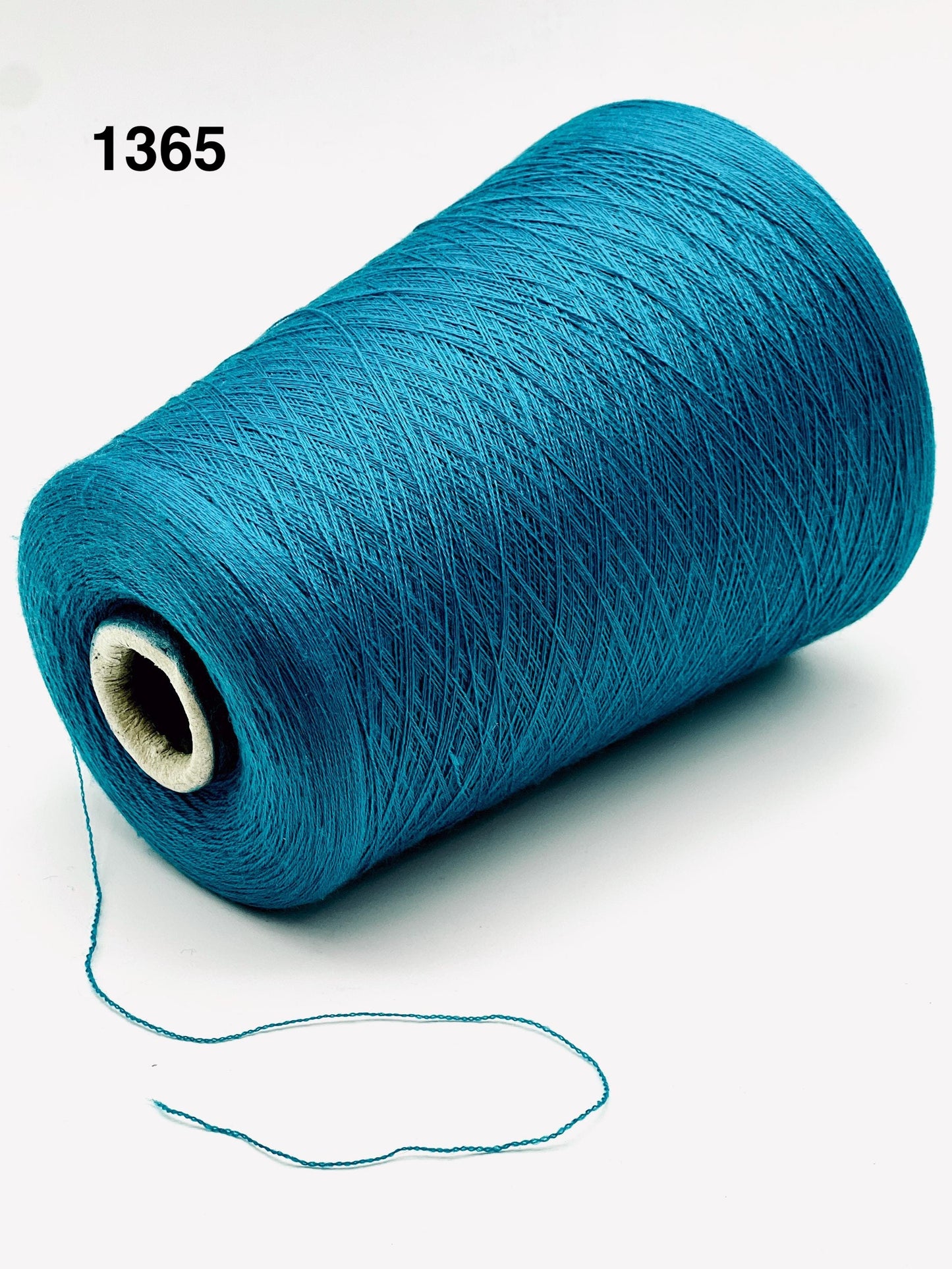 Blue spool of yarn on a white background