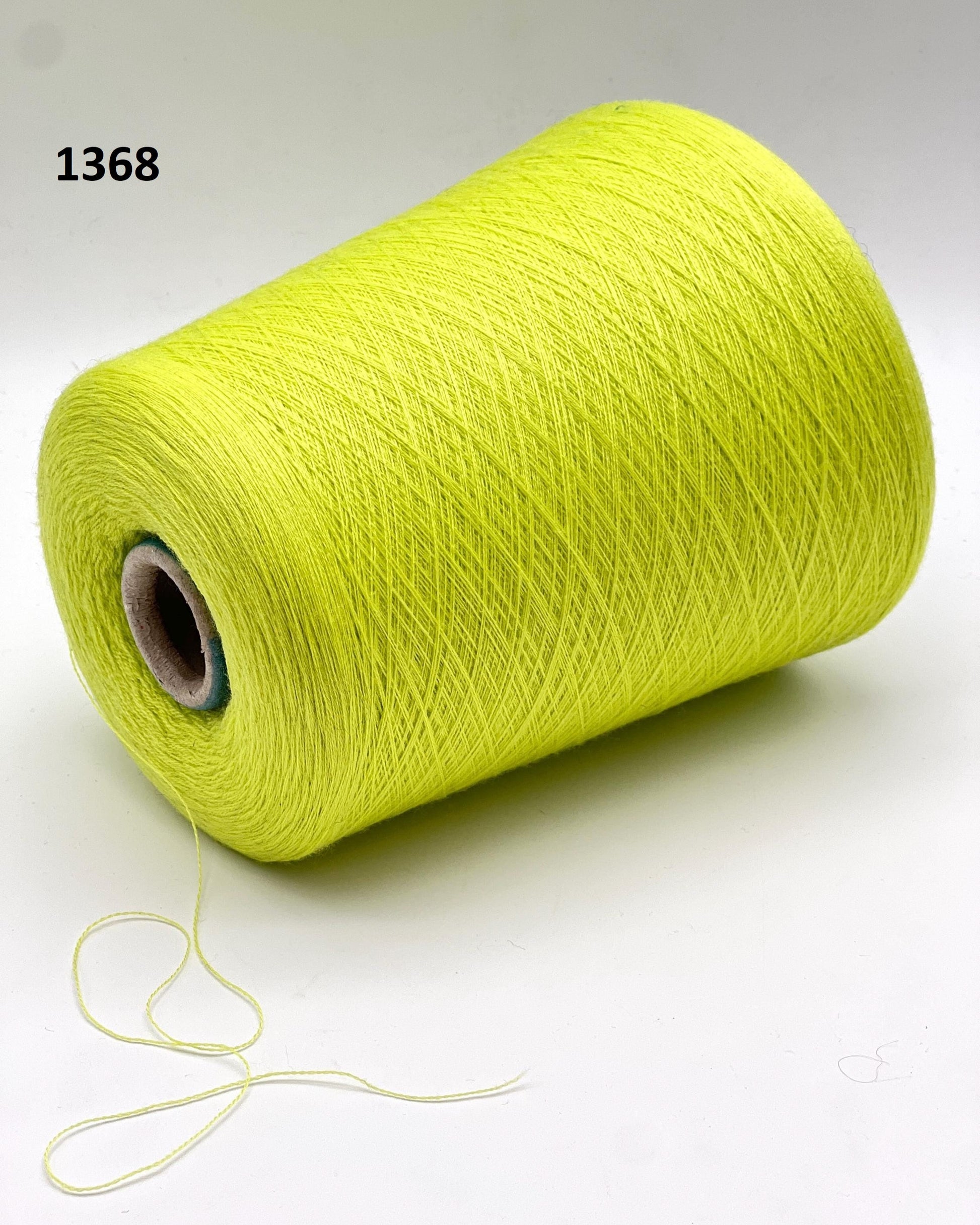 Yellow spool of thread on a white background