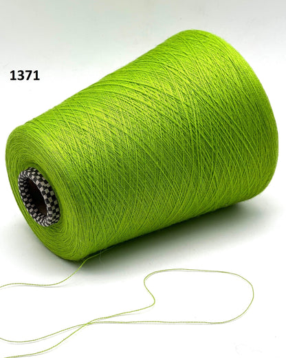 Green spool of thread on a white background