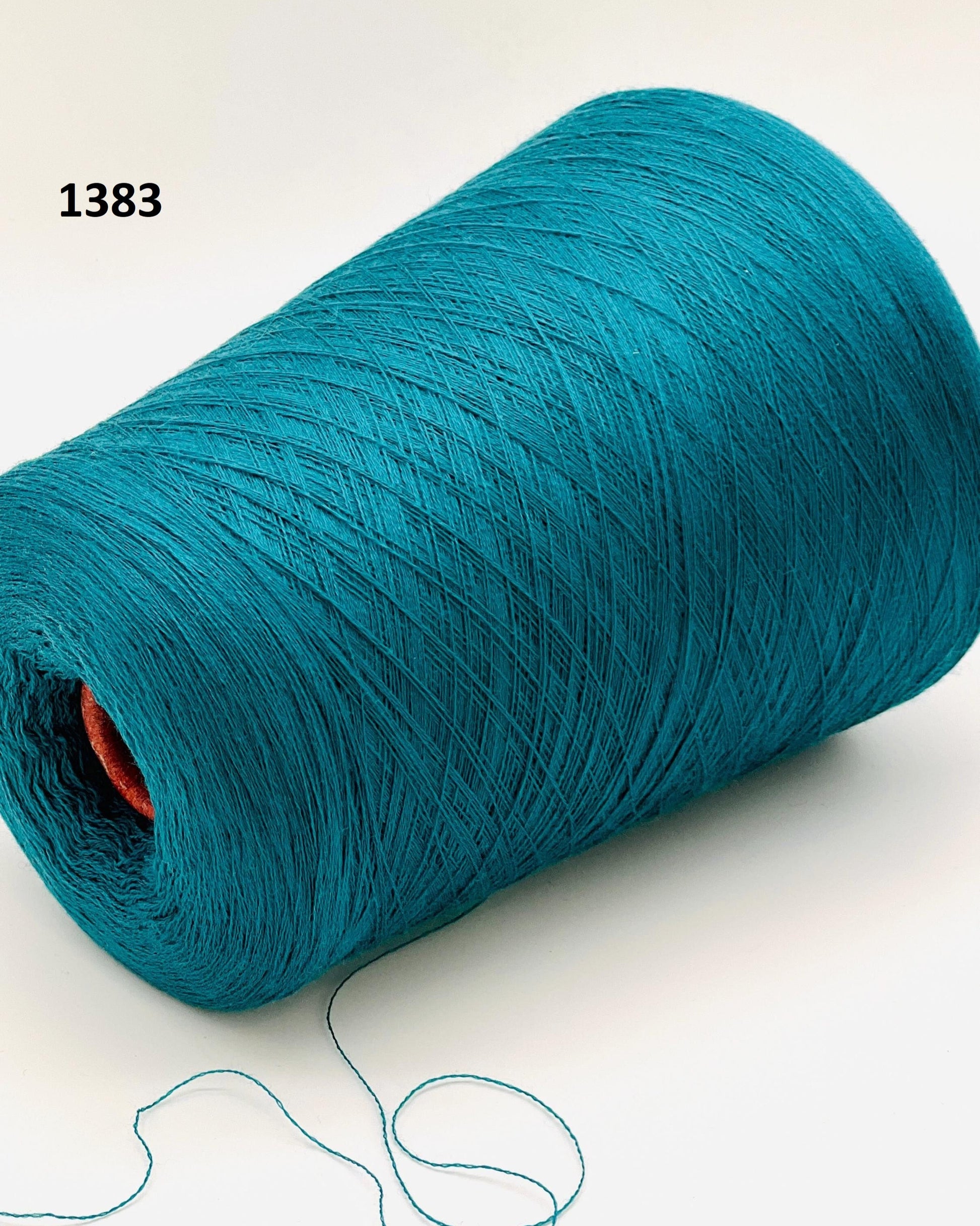 Teal spool of yarn on a white background