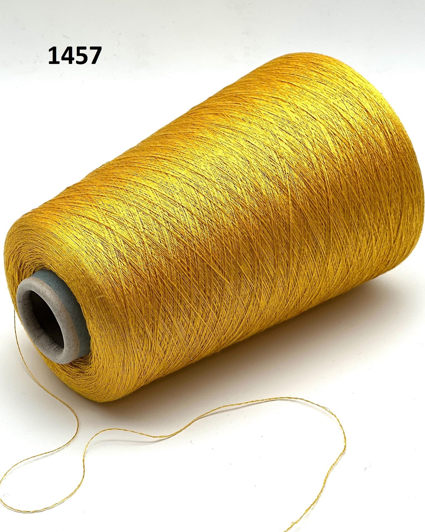 Spool of yellow thread on a white background