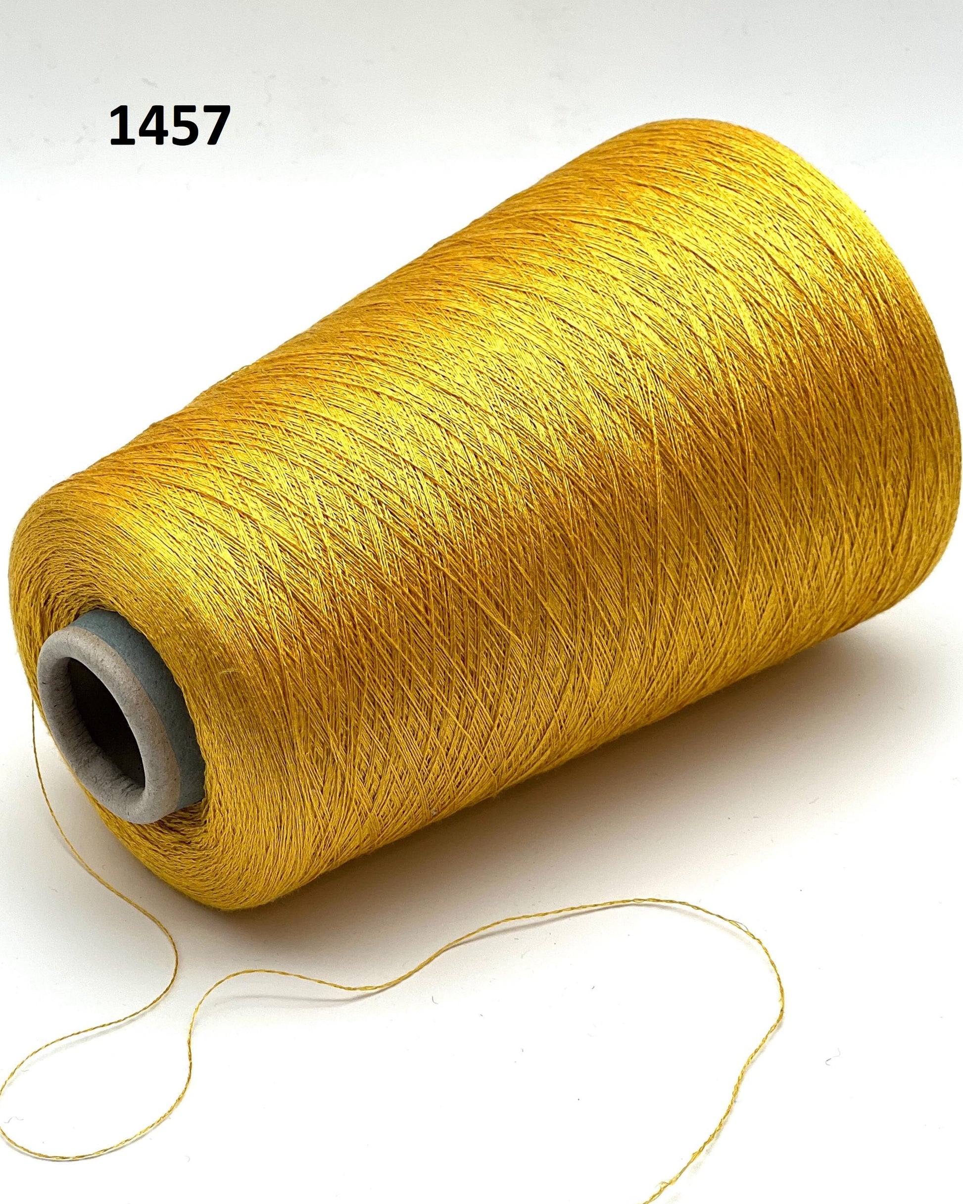 Spool of yellow thread on a white background