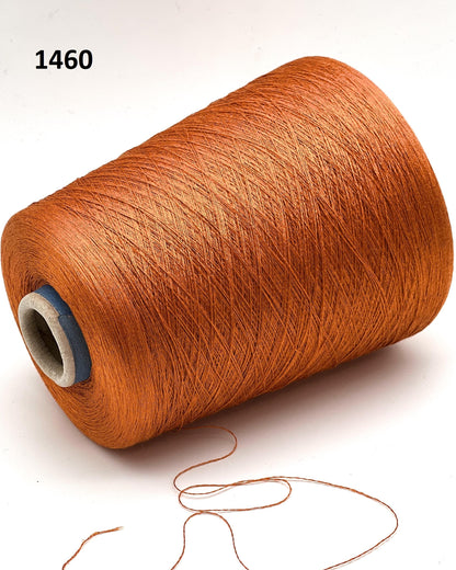 Brown spool of thread with a small amount of thread hanging out on a white background