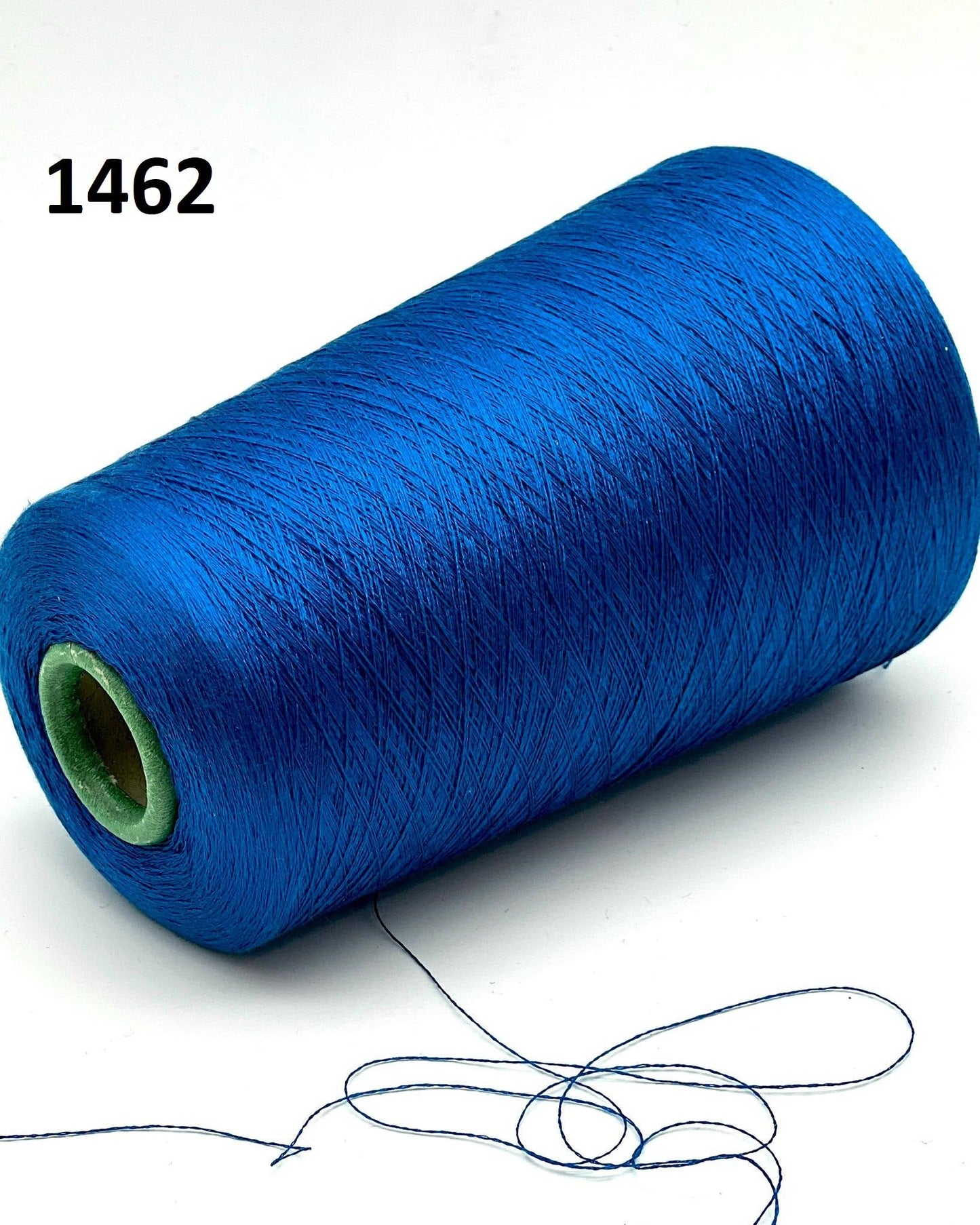 Blue spool of thread with a white background