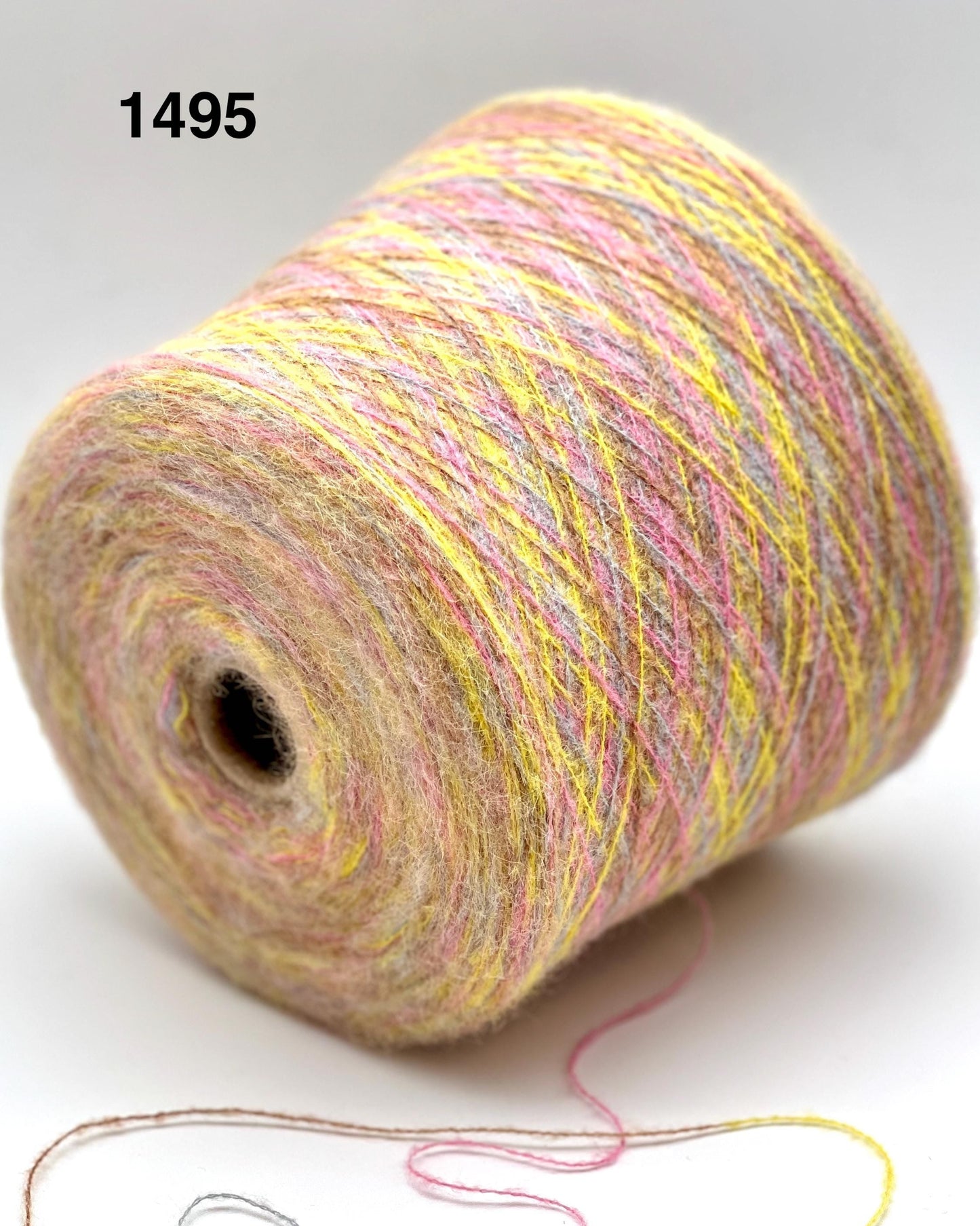Spool of multicolored yarn on a white background