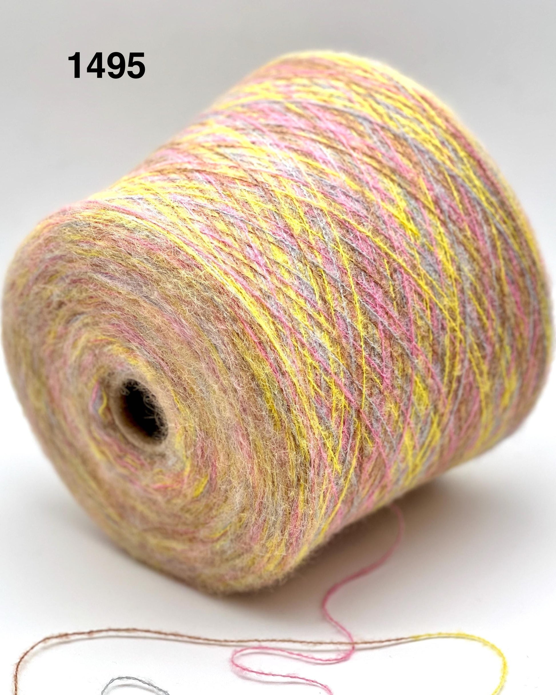 Spool of multicolored yarn on a white background