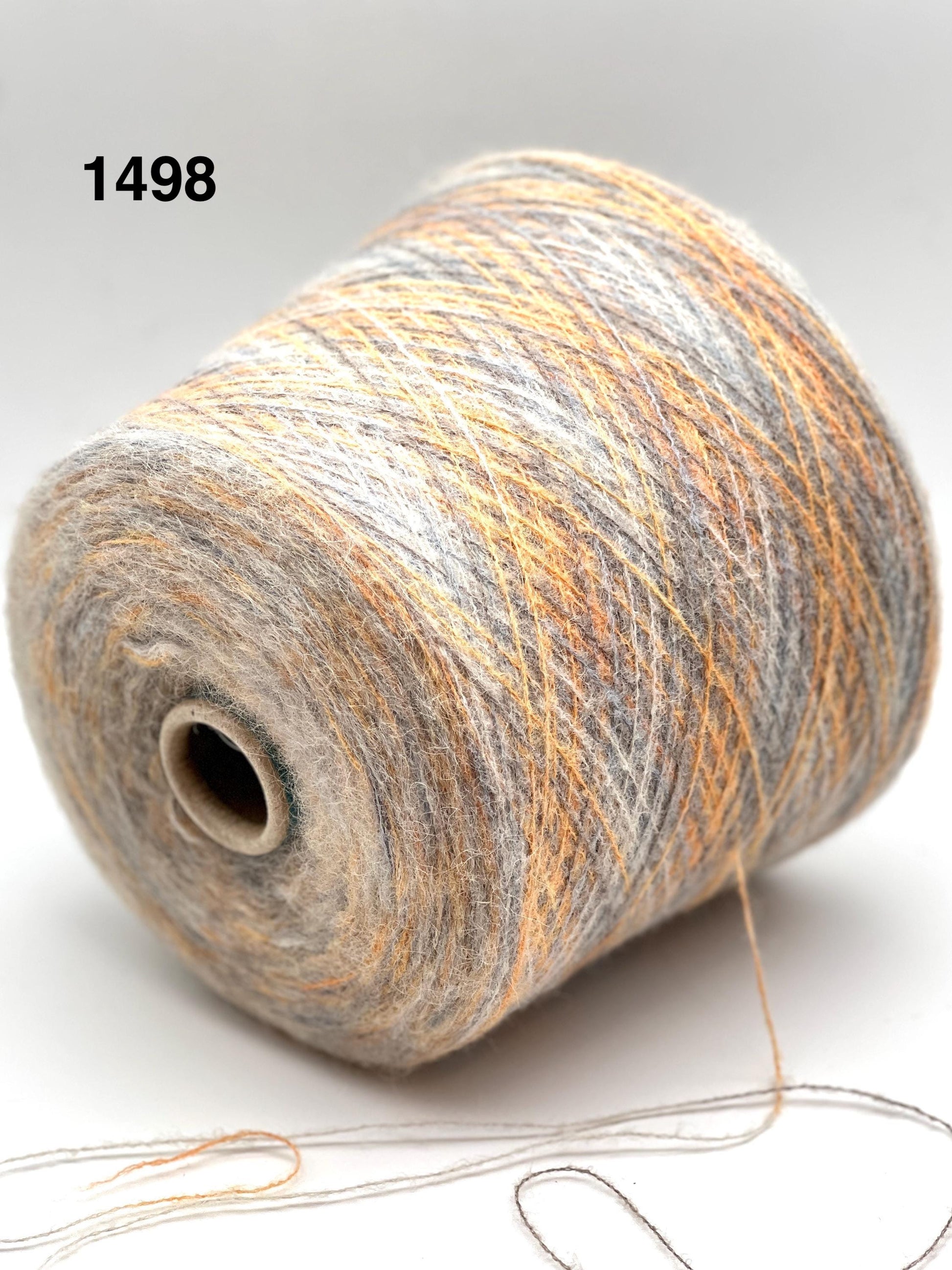 Spool of multicolored yarn on a white background