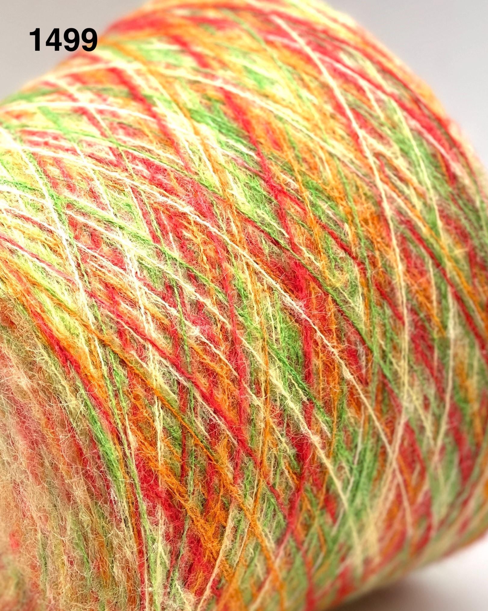 Multicolored yarn ball with a gradient of red, orange, and green on a white background.