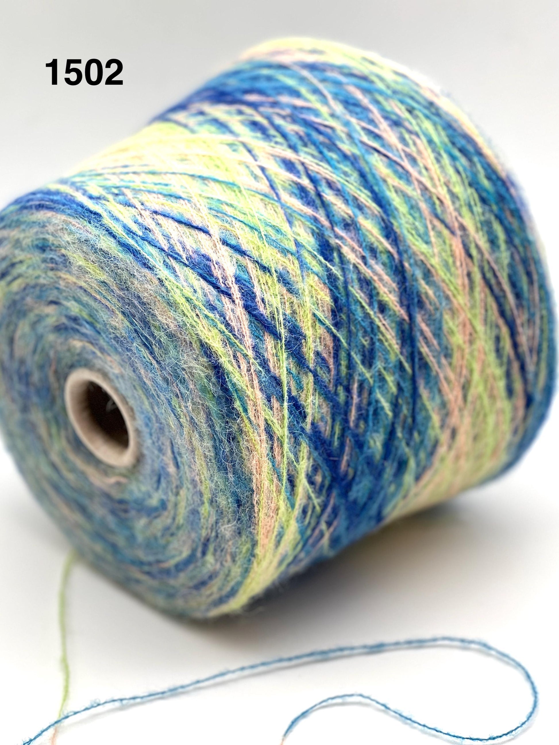 Spool of multicolored yarn on a white background