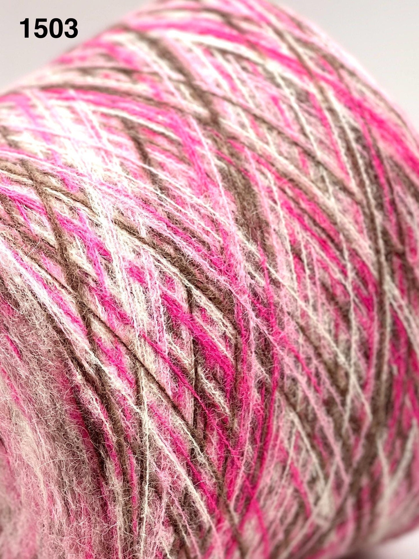 Close-up of a ball of yarn with pink and brown colors.