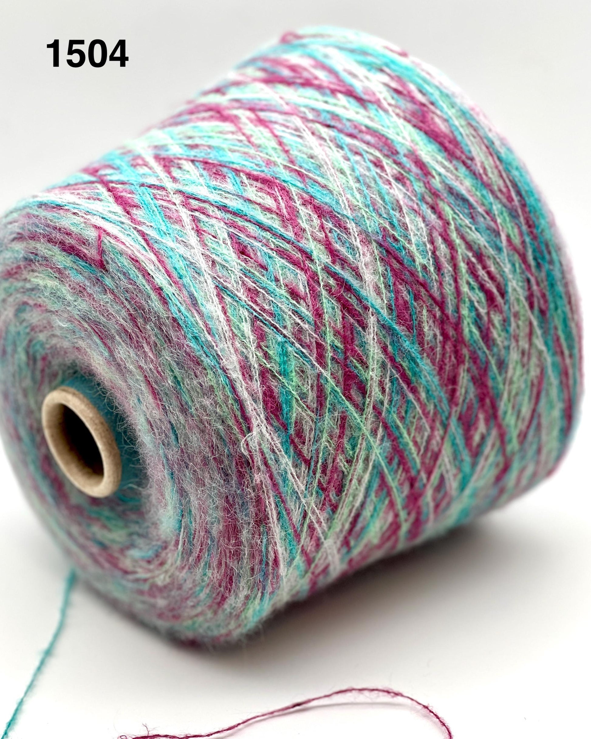 Spool of multicolored yarn on a white background
