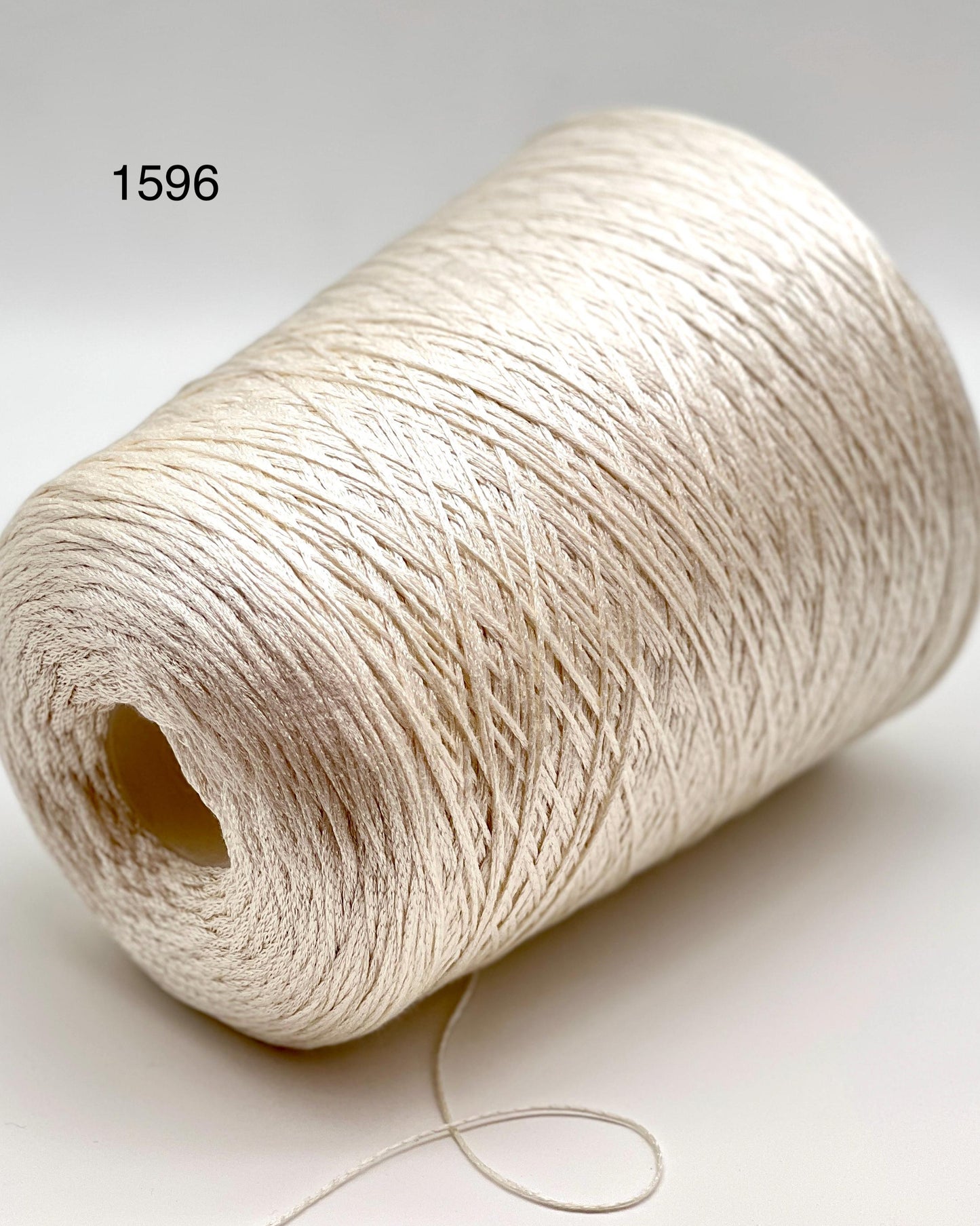 Luxury iDOKNiT fine weight yarn, SETA SHAPPE by Filati Buratti Italy. 100% Seta Shappe Silk with a unique chainette construction for superior elasticity and drape, 600m/100g. Authentic Italian-made silk on cones, color 2153 White, curated by iDOKNiT for high-end hand and machine knitting projects.