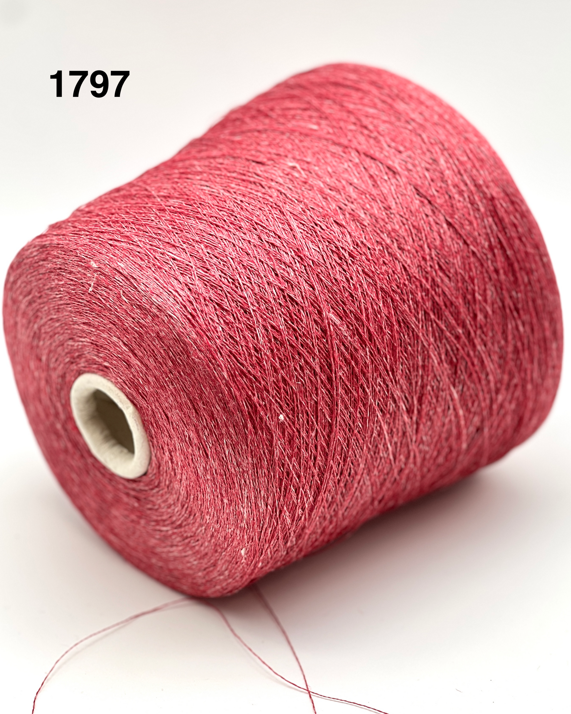 Red spool of yarn on a white background