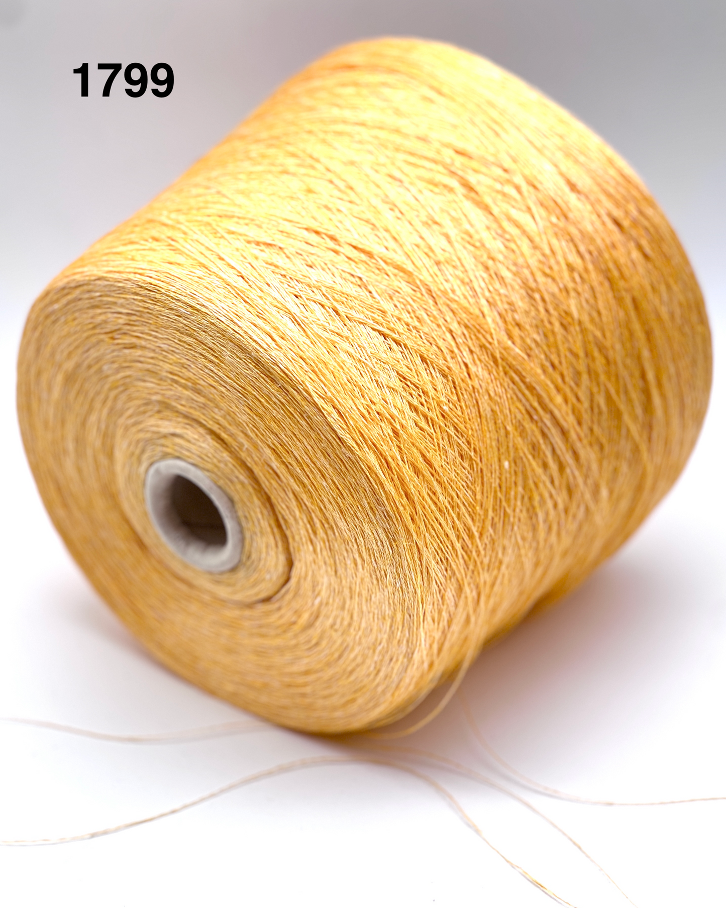 Spool of beige yarn on a white background