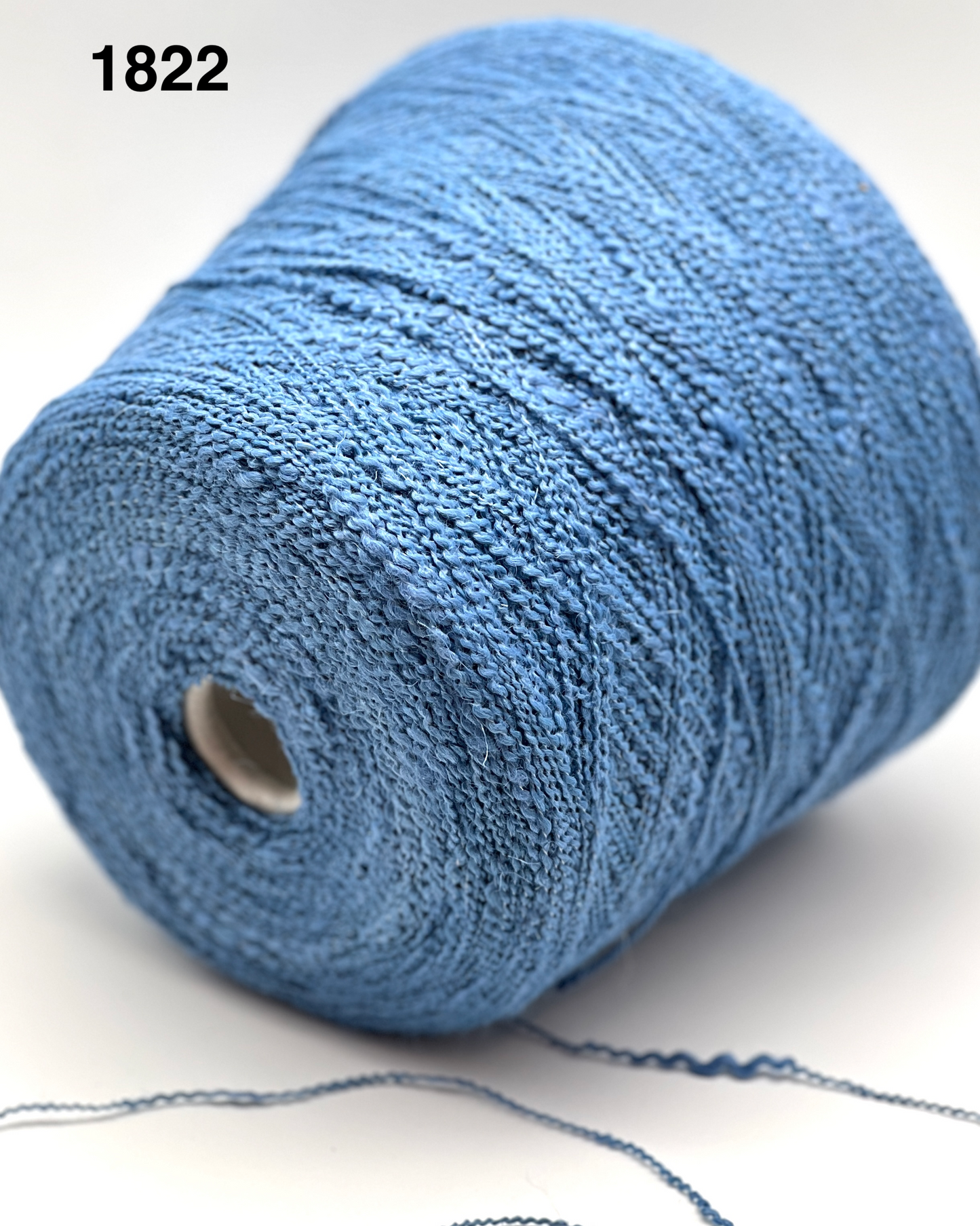 Blue yarn spool on a white background