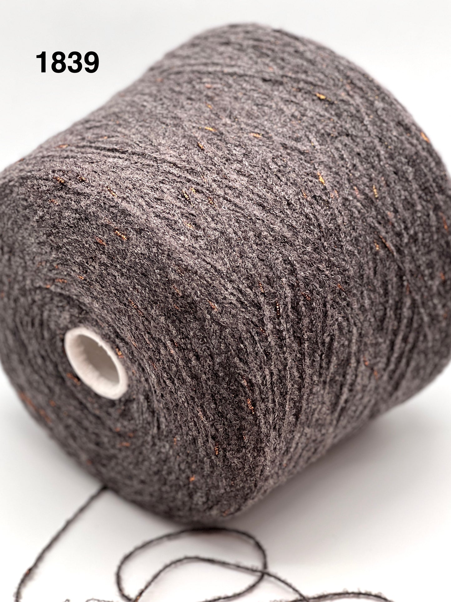 Close-up of a skein of dark gray yarn on a white background, color number 1839