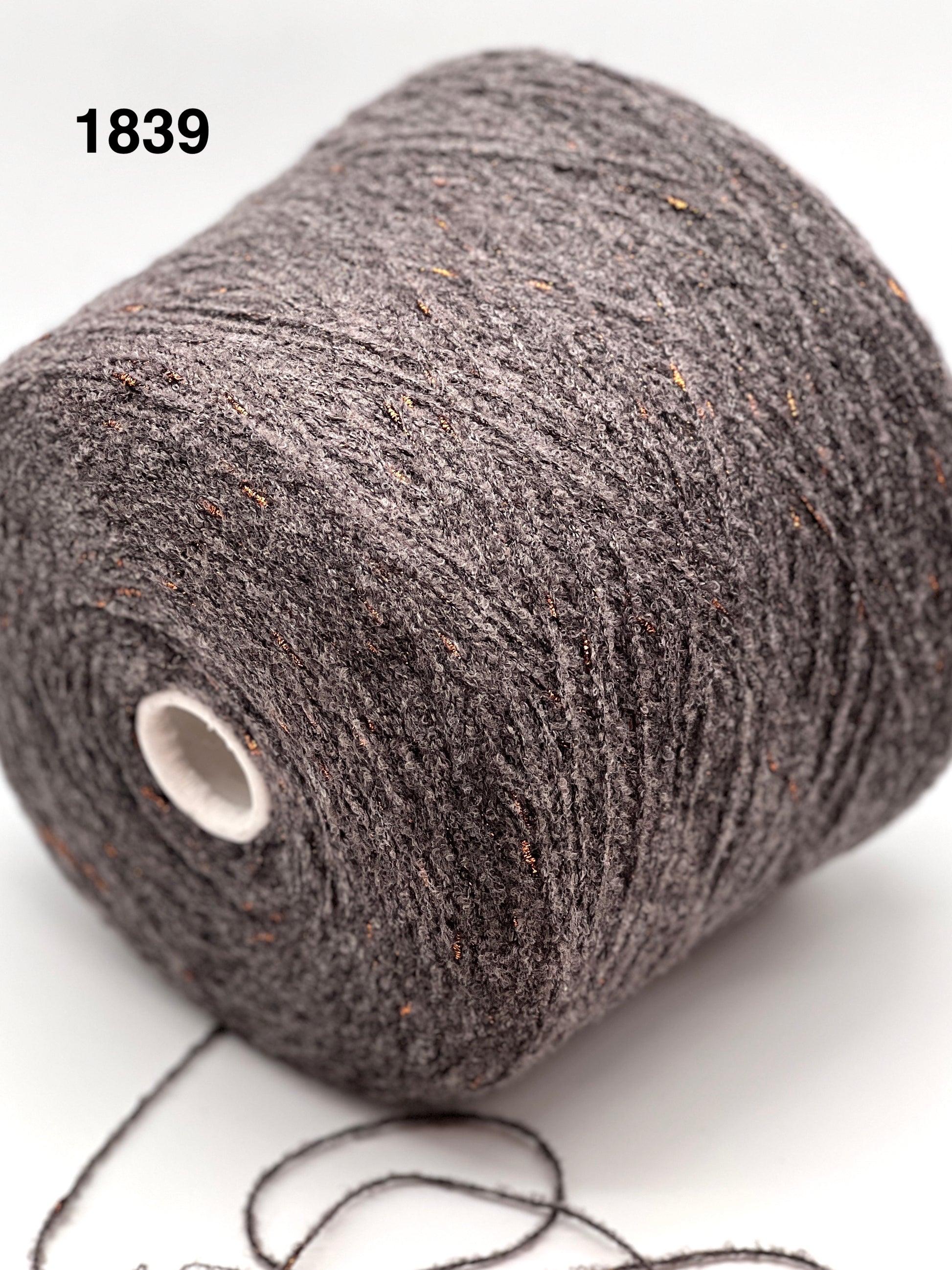 Close-up of a skein of dark gray yarn on a white background, color number 1839