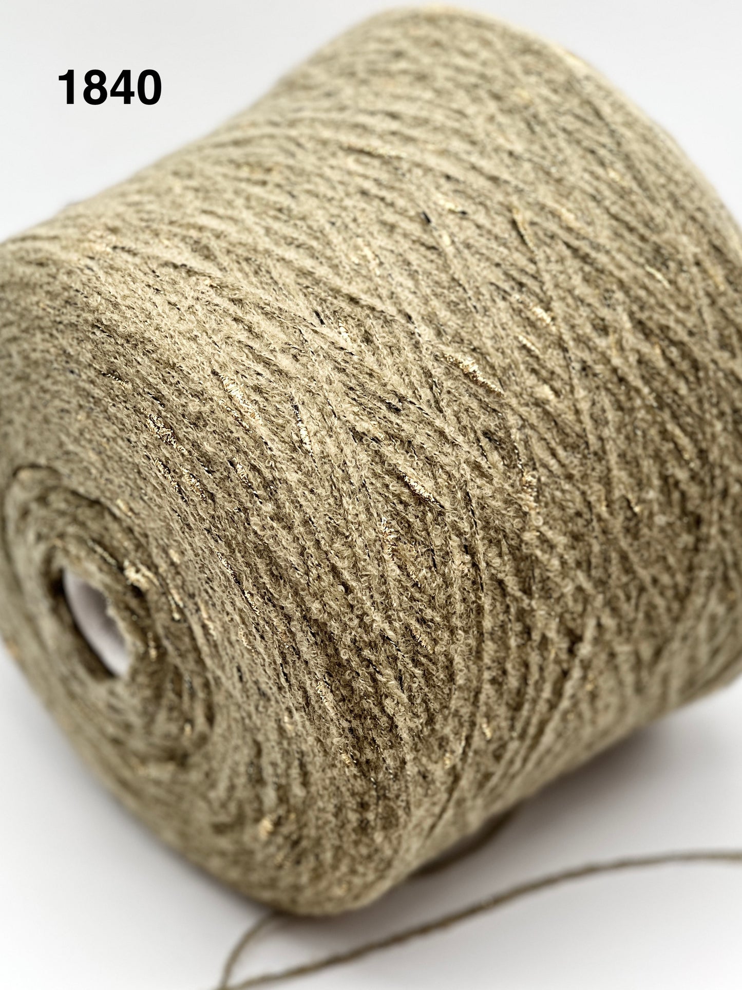 Close-up of a roll of beige twine with a white background, color 1840