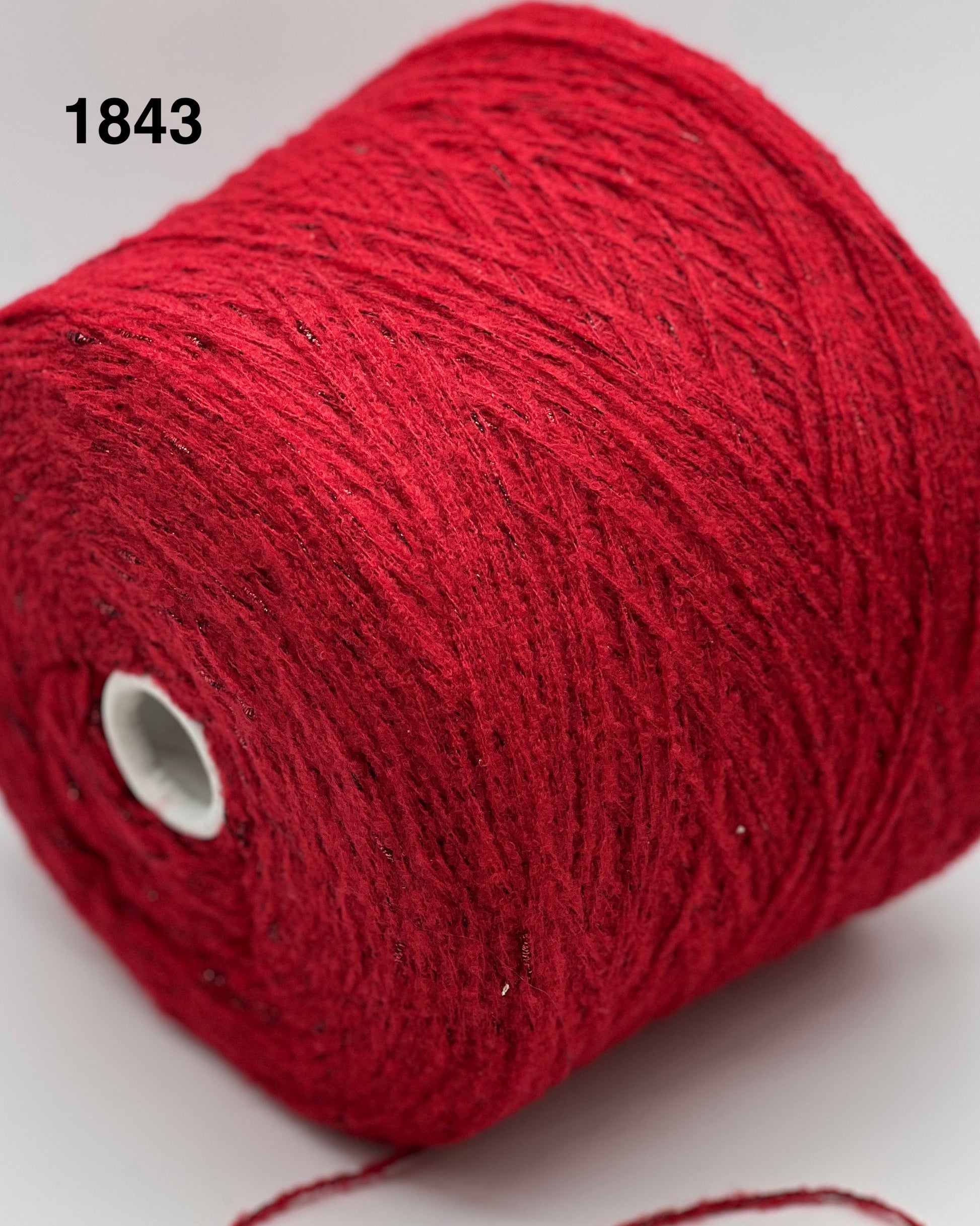 Red yarn spool on a white background, color 1843