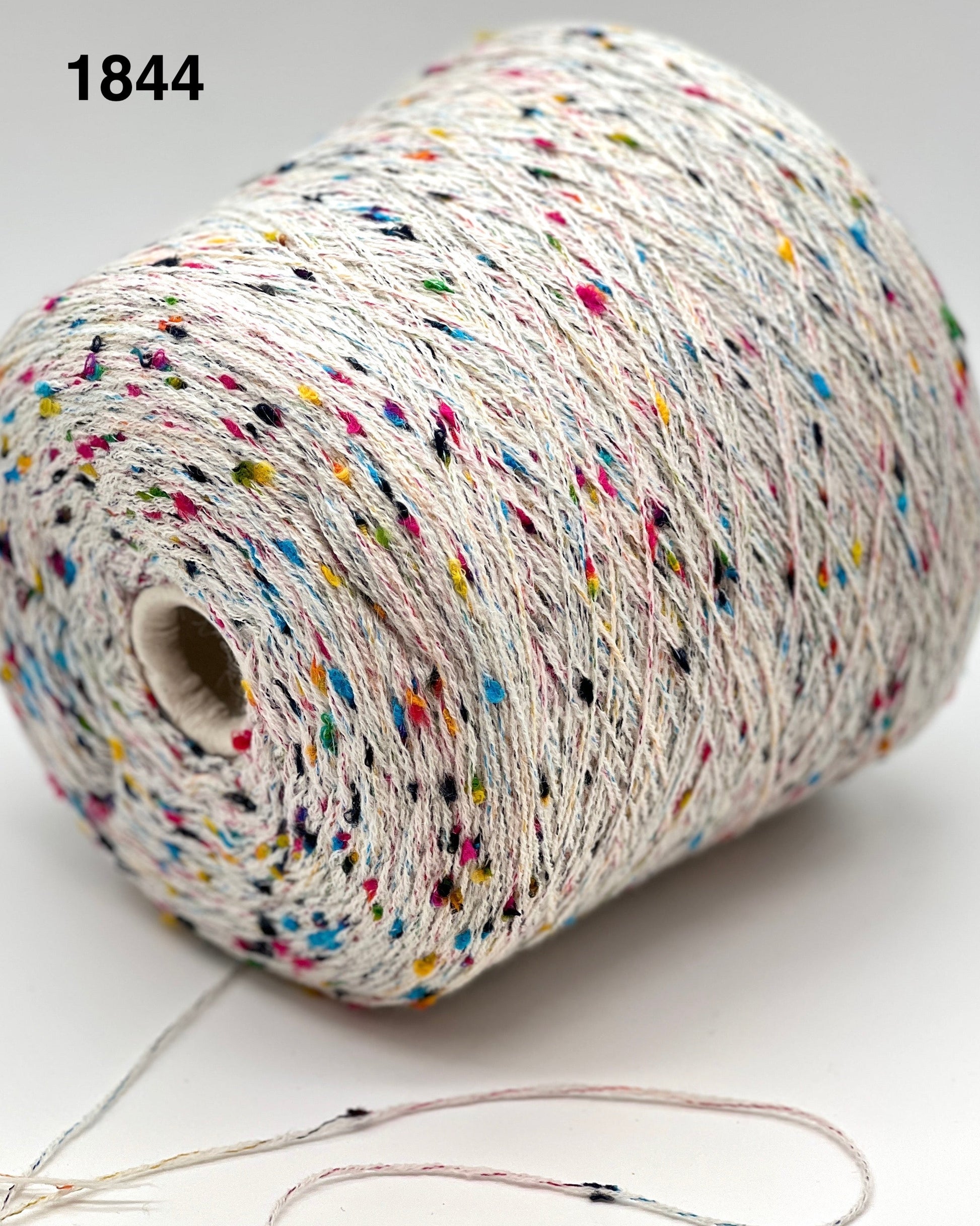 Spool of multicolored yarn on a white background