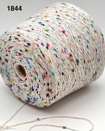 Spool of multicolored yarn on a white background