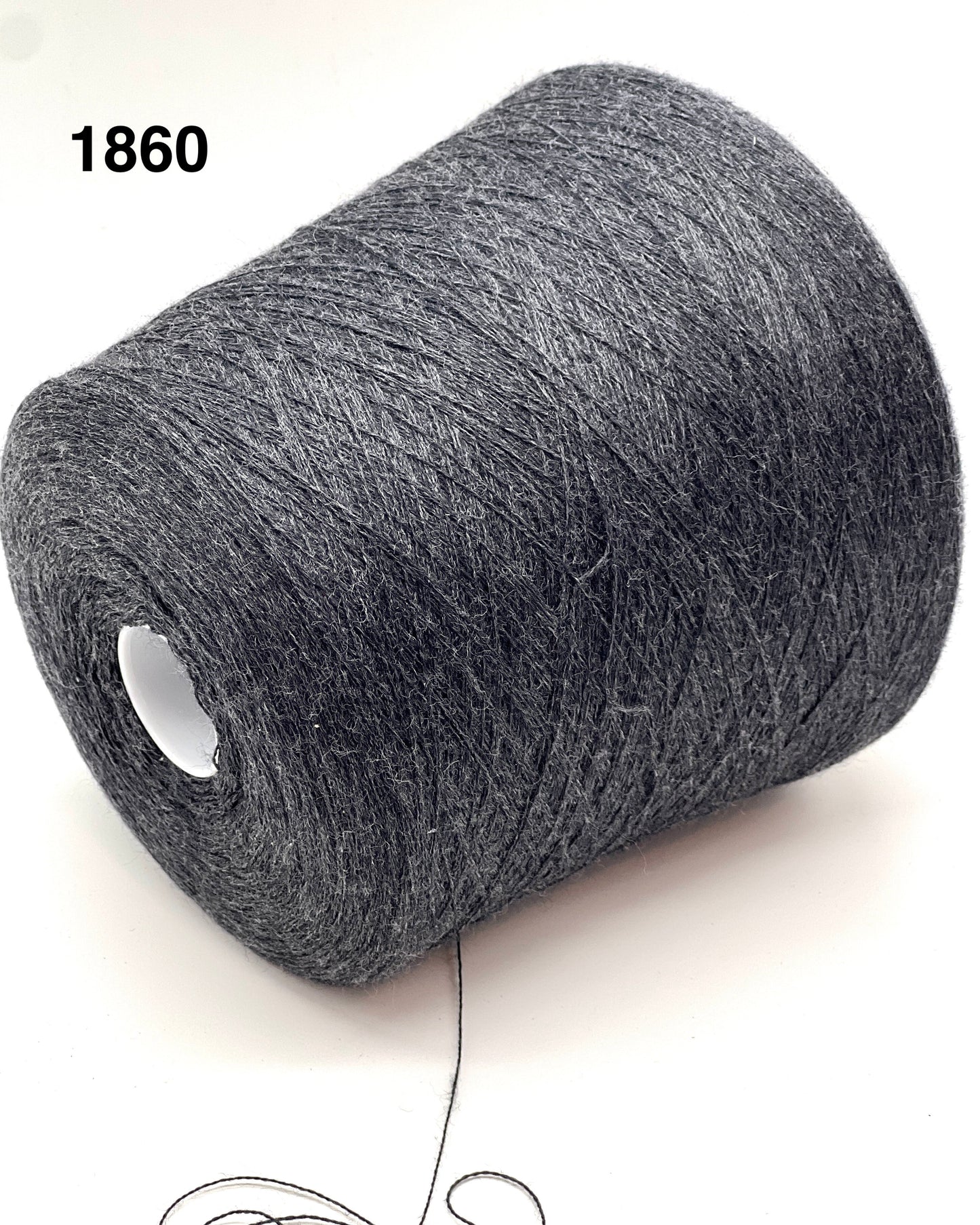 Roll of gray yarn on a white background