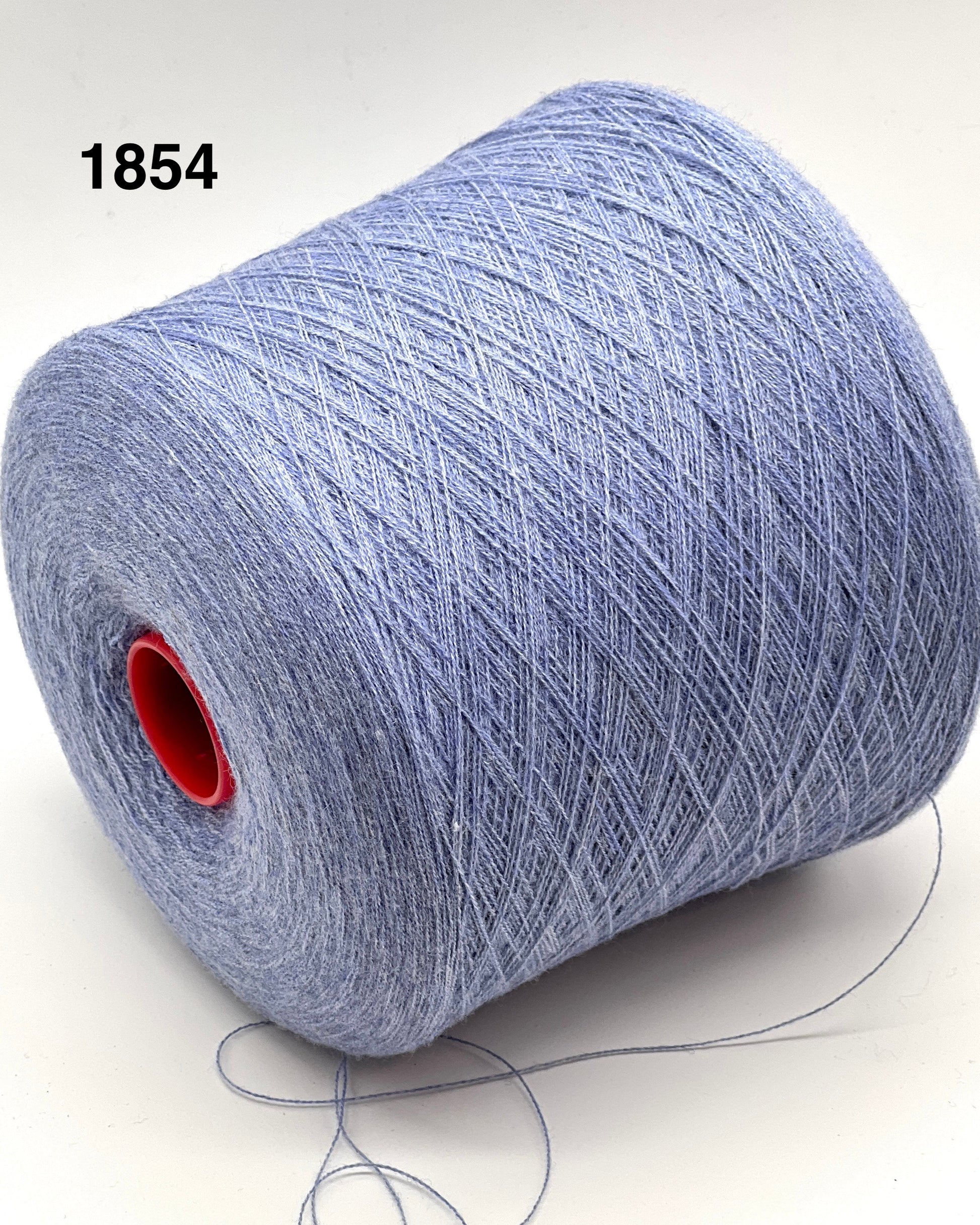 Spool of blue yarn with a red core on a white background