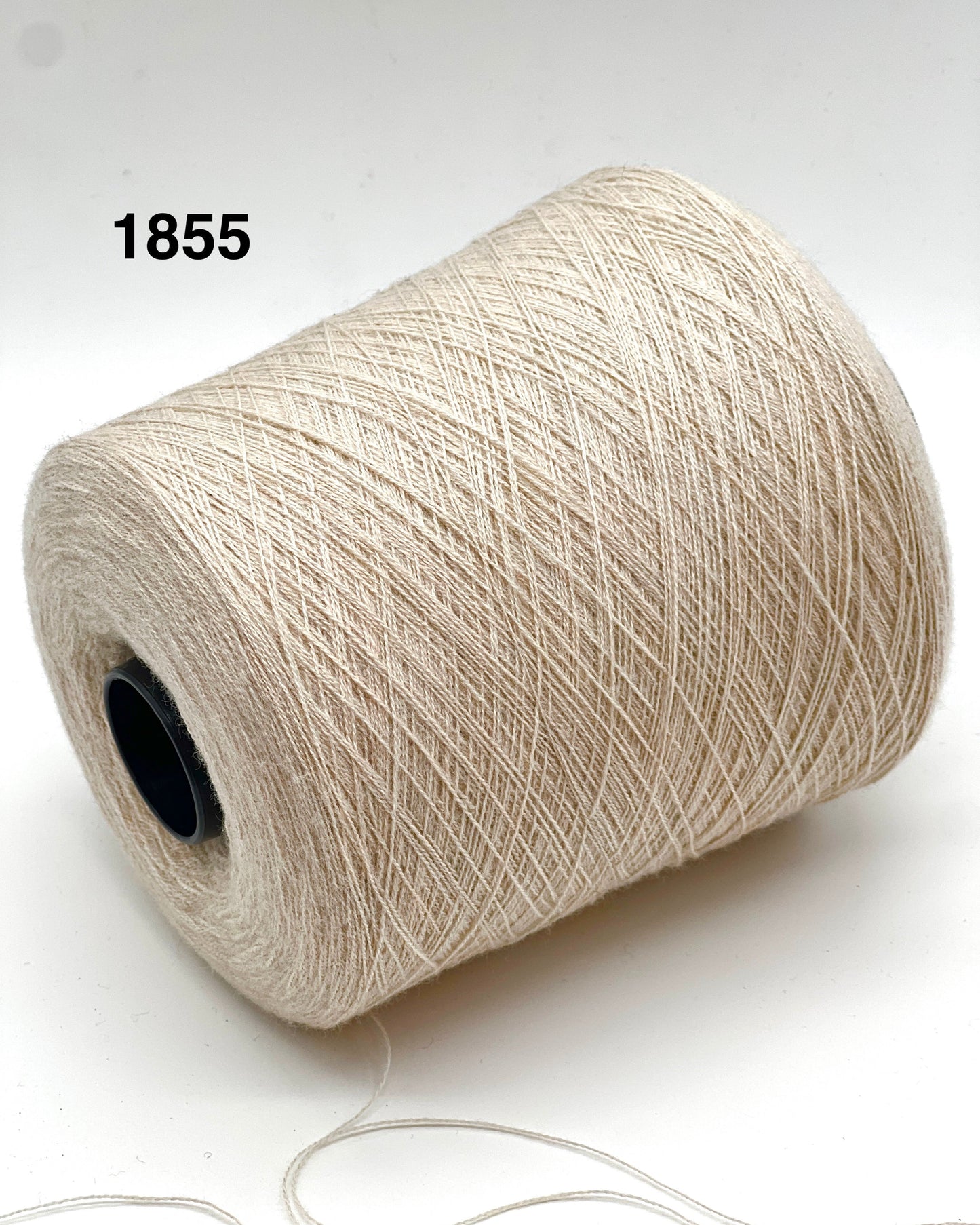 Spool of beige yarn on a white background with number 1855.