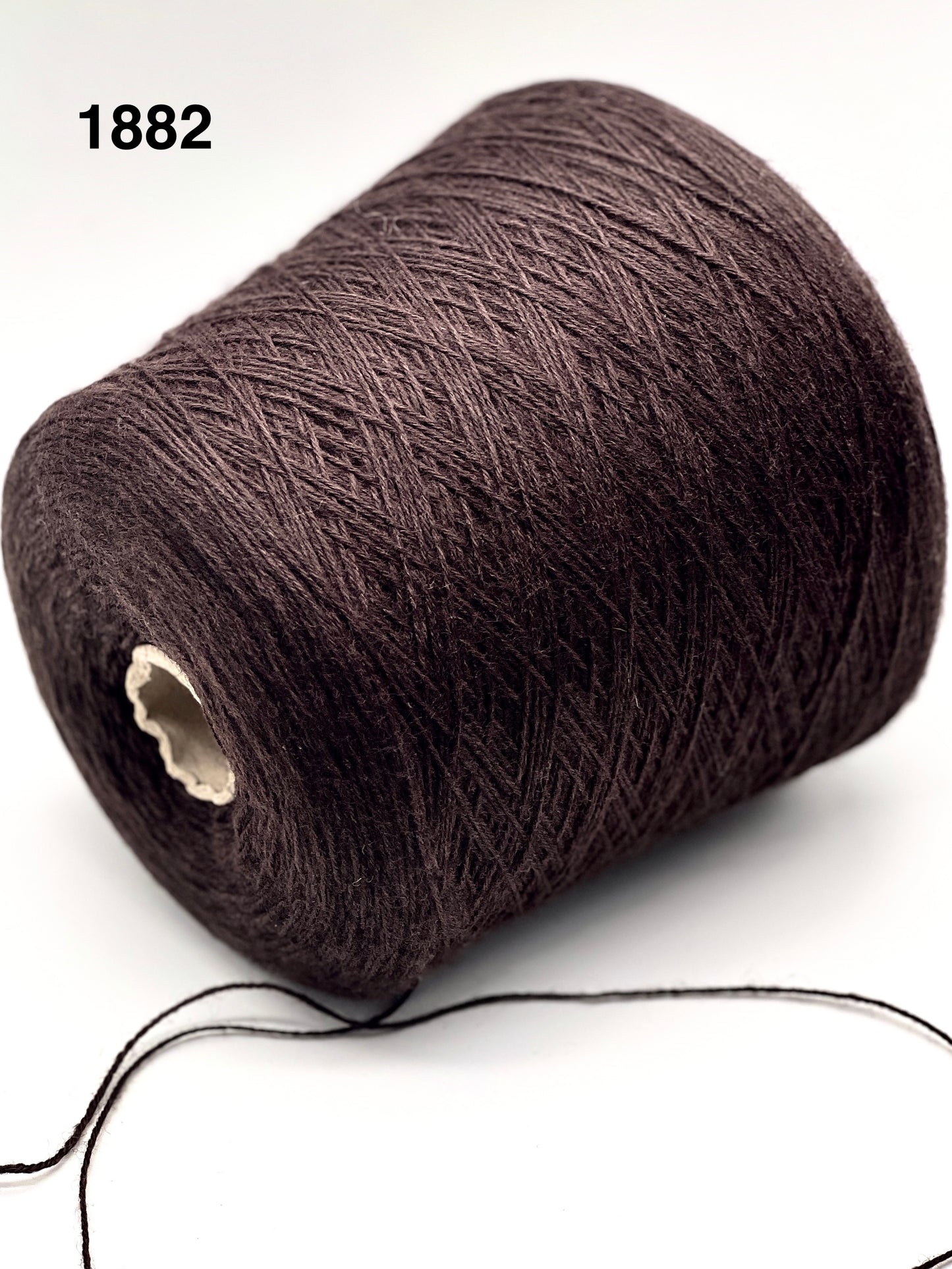 Brown yarn spool on a white background