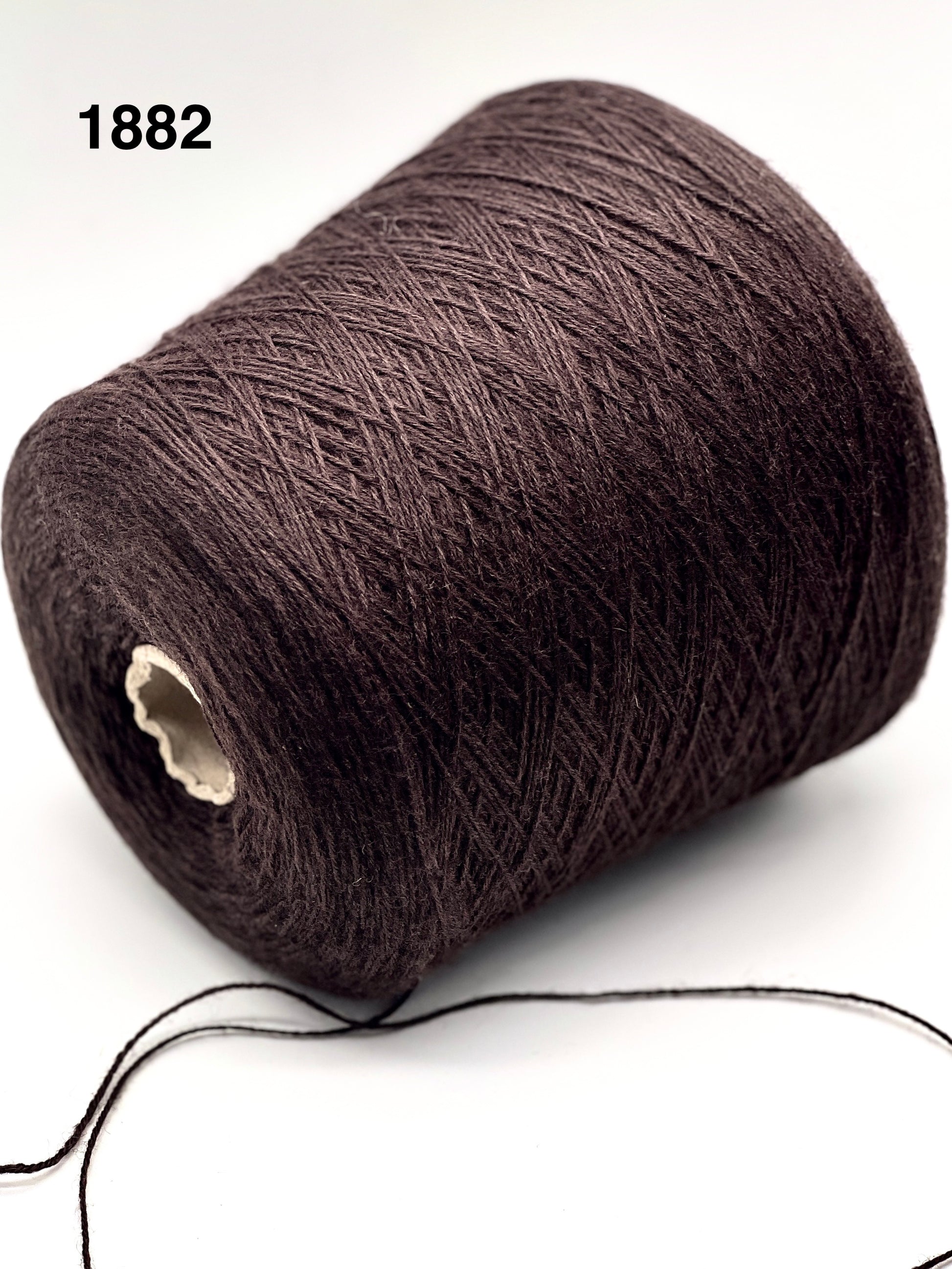 Brown yarn spool on a white background