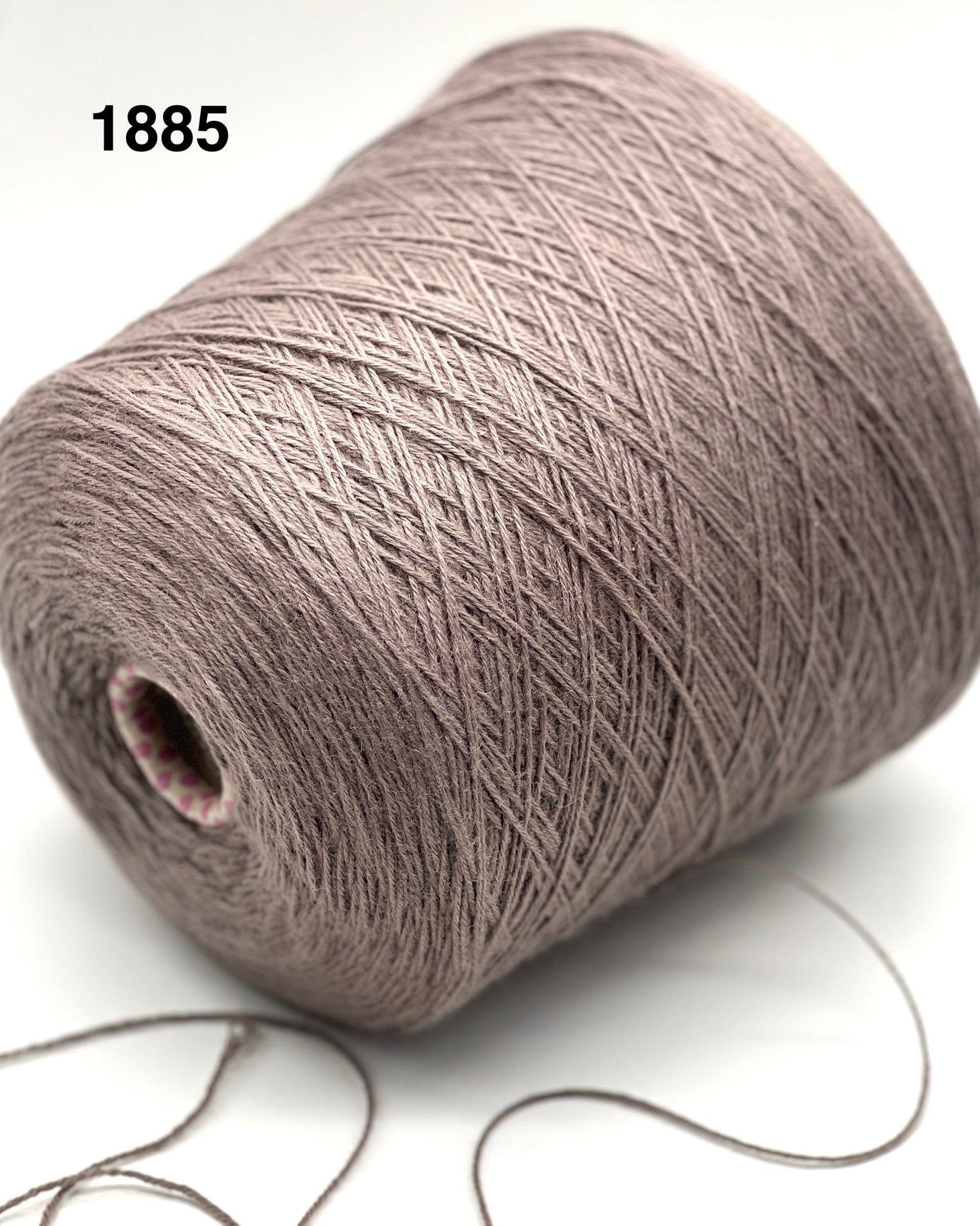 Spool of gray yarn on a white background
