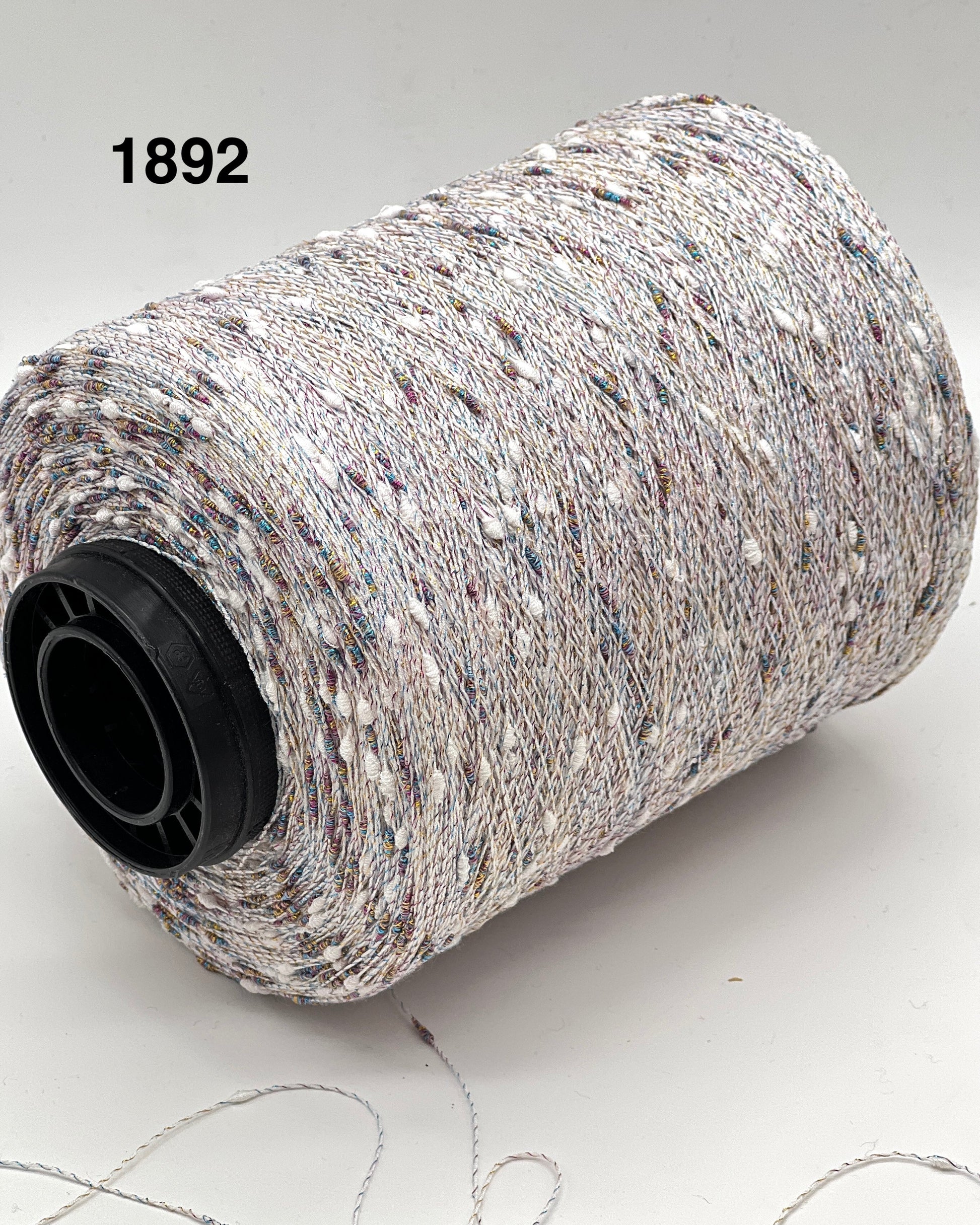 Spool of gray yarn with a black core on a light background