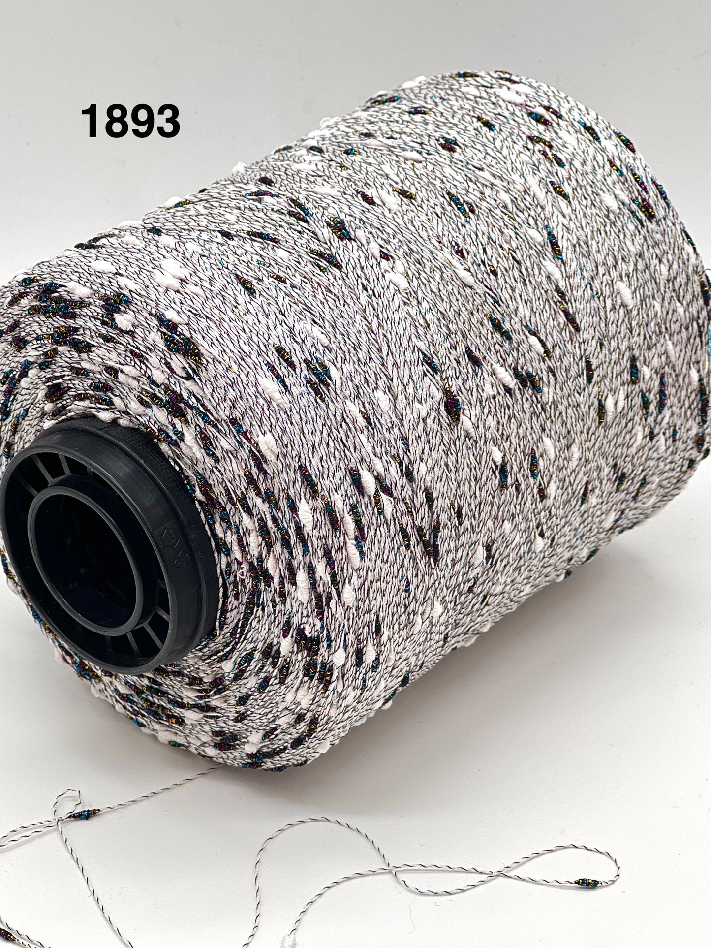 Spool of black and white string with a visible brand number on a light background