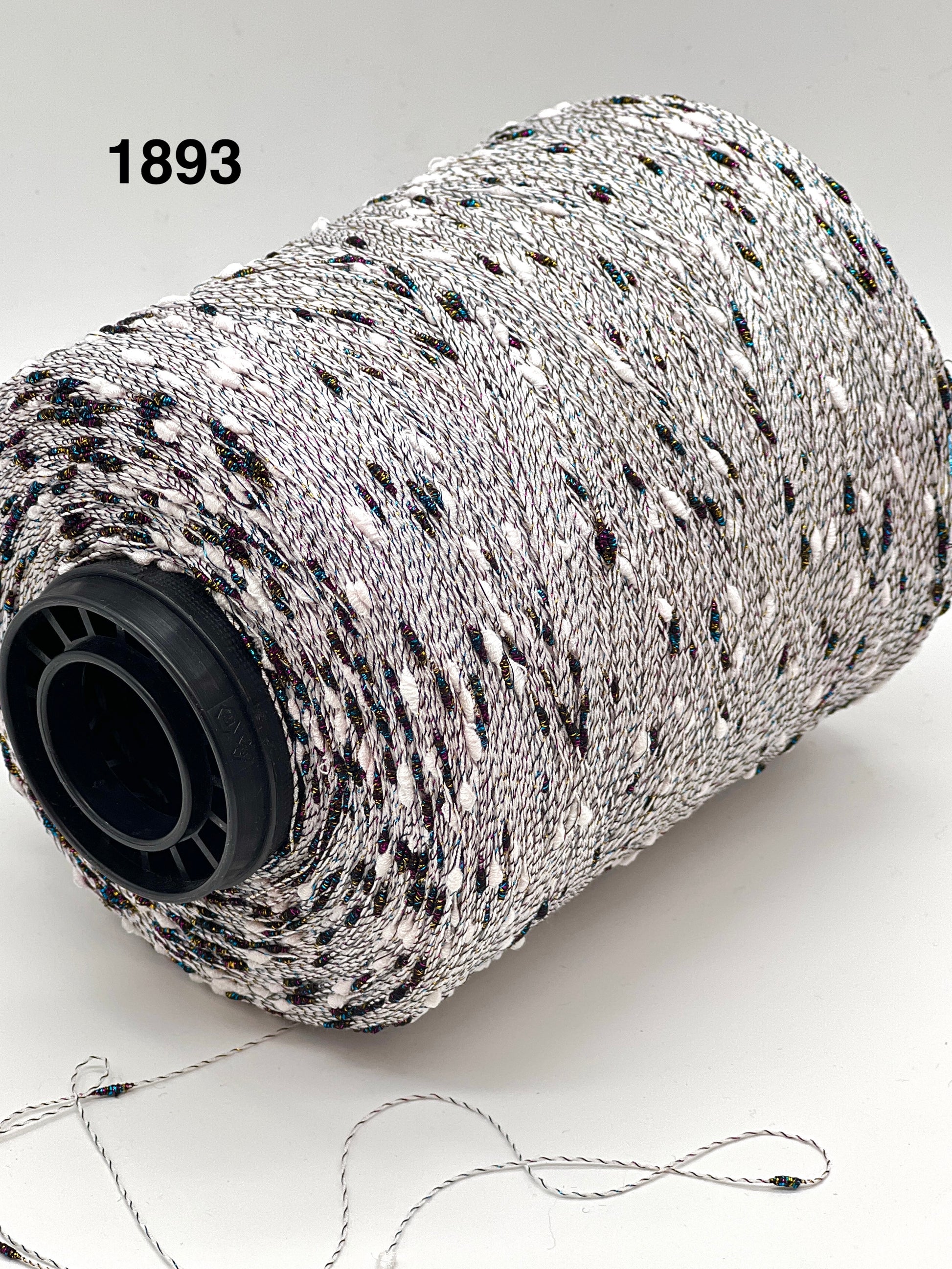 Spool of black and white string with a visible brand number on a light background