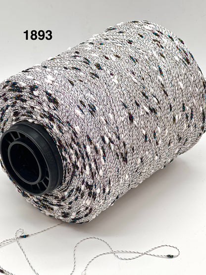 Spool of black and white string with a visible brand number on a light background