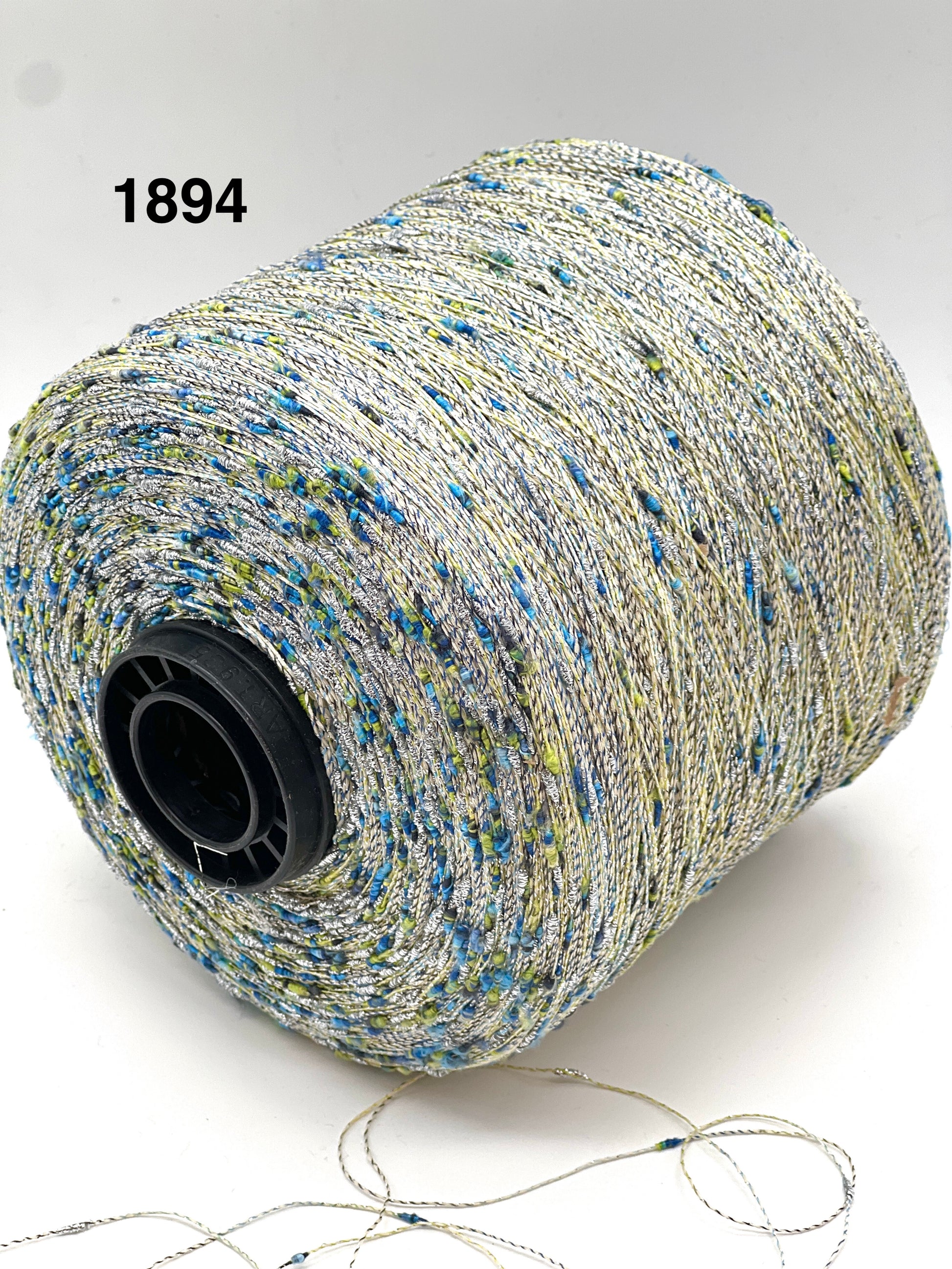 Spool of multicolored thread with a visible brand number on a white background