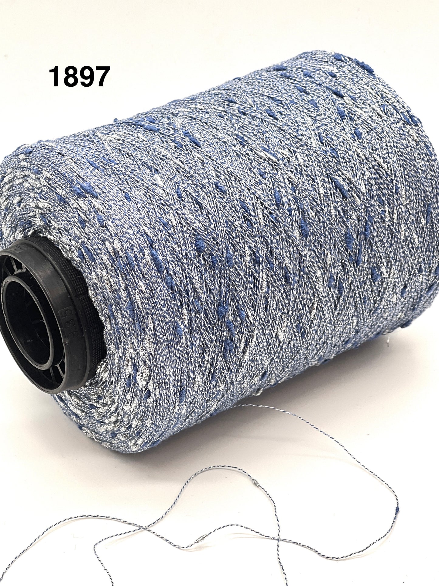 Spool of blue and white thread with a small sample of thread on a white background