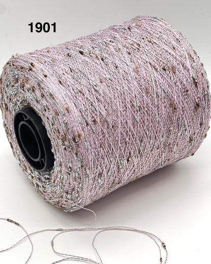 Spool of thread with a small amount on the ground, on a white background