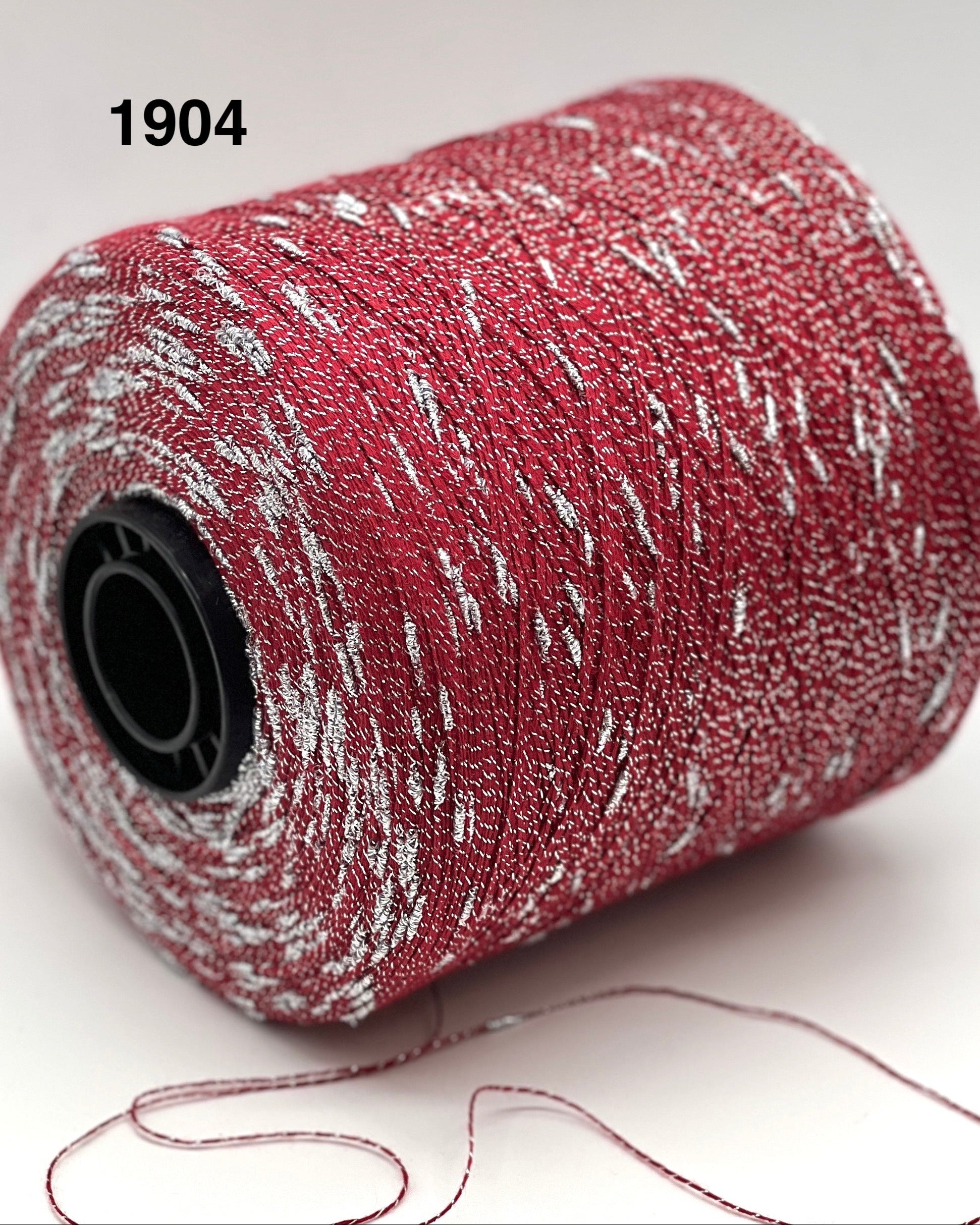 Roll of red and white textured material with a black core on a light gray background.