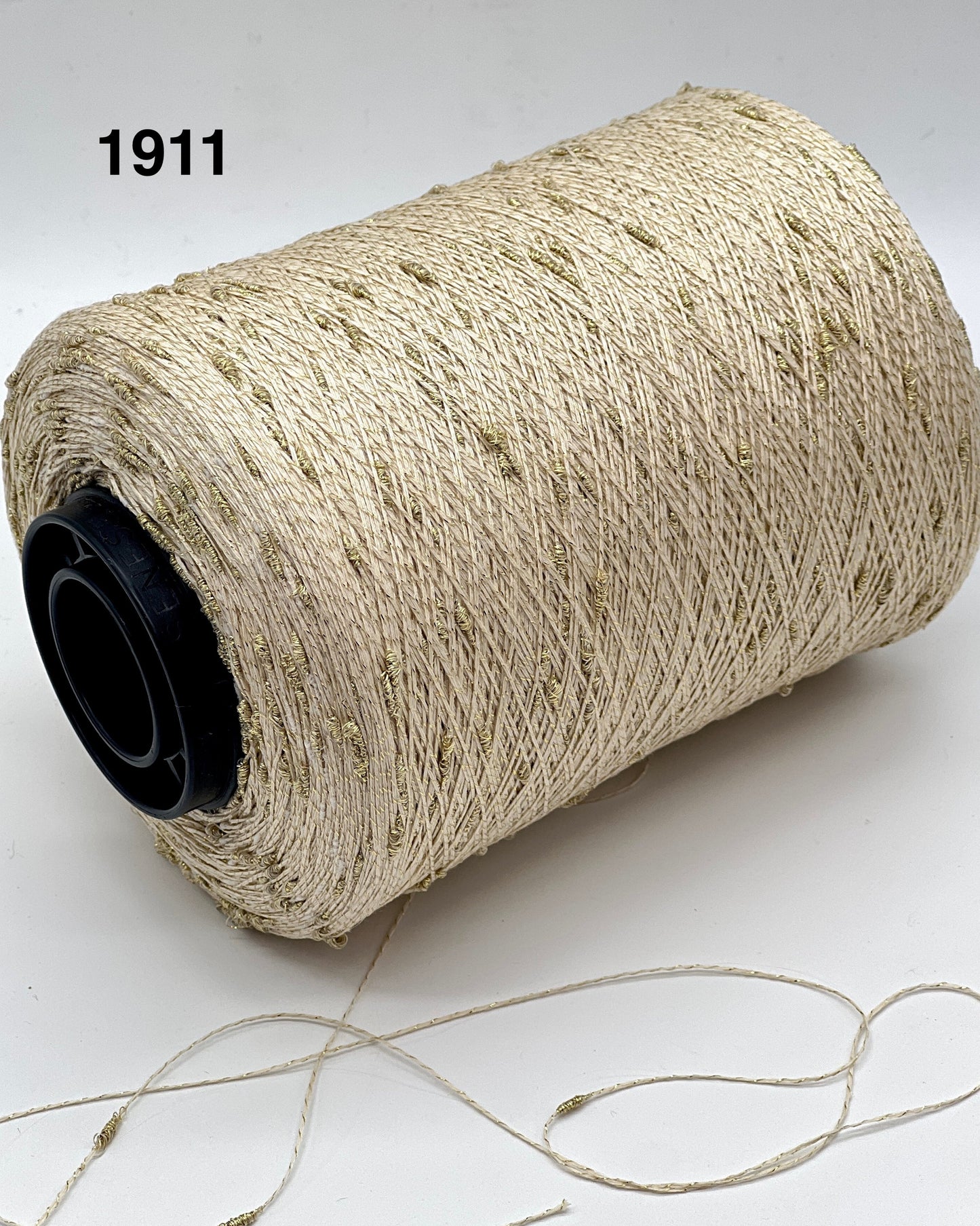 Spool of beige thread with a black core on a white background, labeled '1911'.