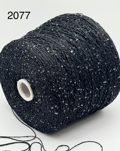 Professional grade RiGo STELLATO sport weight yarn from iDOKNiT, featuring a sophisticated 60% Italian cotton base with 2mm integrated paillettes. This authentic Italian-made yarn is curated by iDOKNiT to provide a refined shimmer and luxury finish for elegant, high-performance knitting projects.