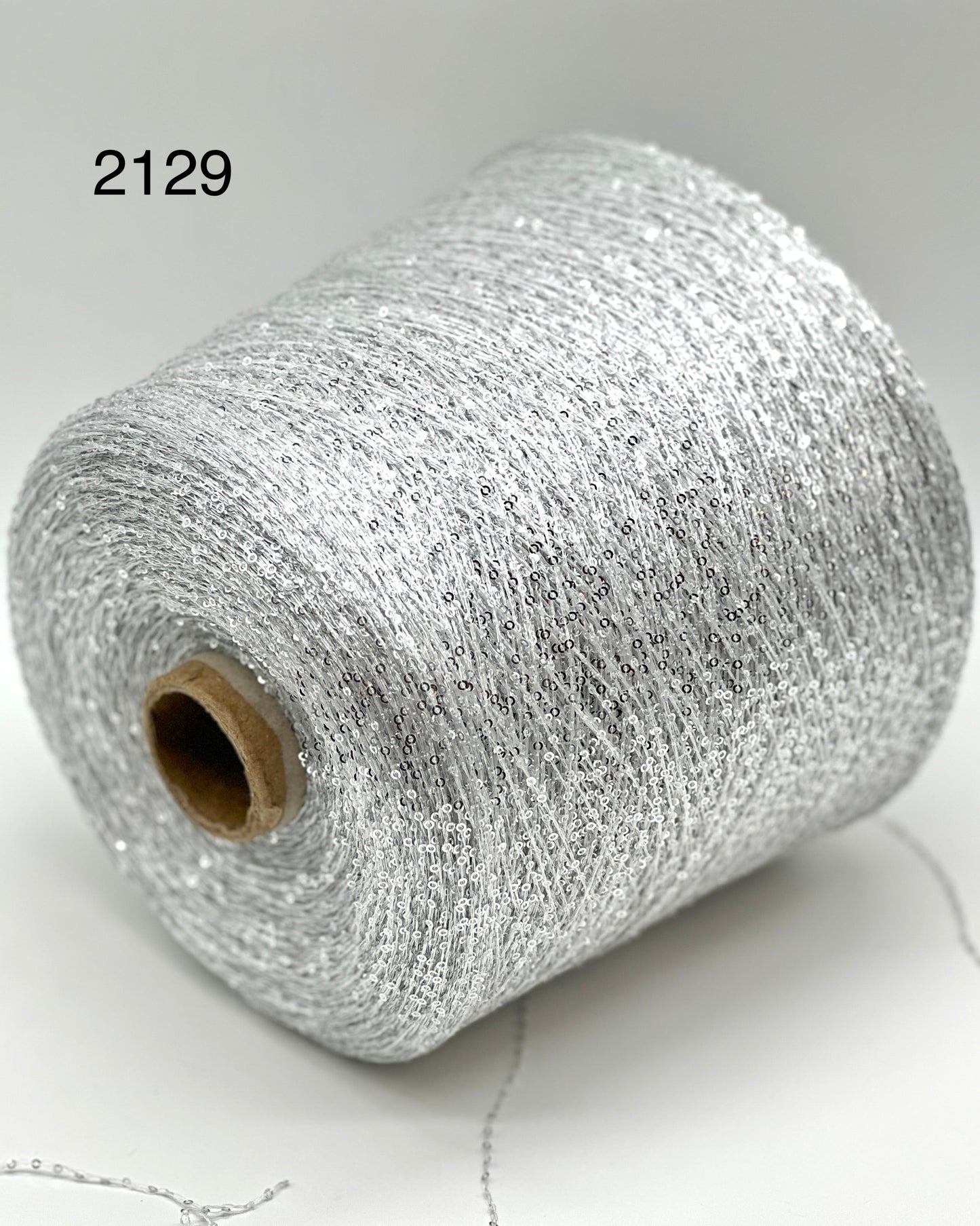 Elite iDOKNiT decorative lace weight yarn, SEQUINS by Cofil Italy. 100% polyester with micro-sequins, 460m/100g. Authentic Italian-made sparkling carry-along yarn curated by iDOKNiT to add texture and shine to professional knitting projects.