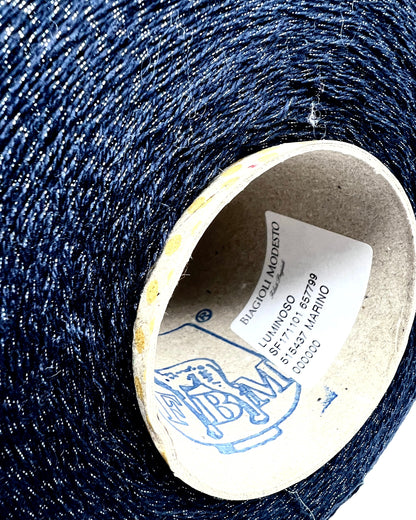 Filati Biagioli Modesto luxury lace yarn shown on a professional cone. This premium Italian blend of cashmere, silk, and cotton features an irregular Lurex thread for subtle shimmer and movement. Sophisticated fashion yarn available at iDOKNiT.com.