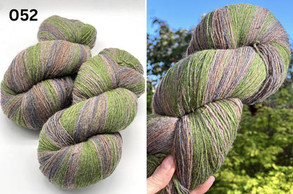 Small-batch dyed heritage skeins of 100% Latvian Dark-Headed Sheep Wool in earthy multicolor gradients like Green-Brown #052. The image shows the rustic single-ply texture and the sheep breed origin, representing the authentic wool traditions of Paces Vilnas Fabrika, Latvia. Available at iDOKNiT.com.